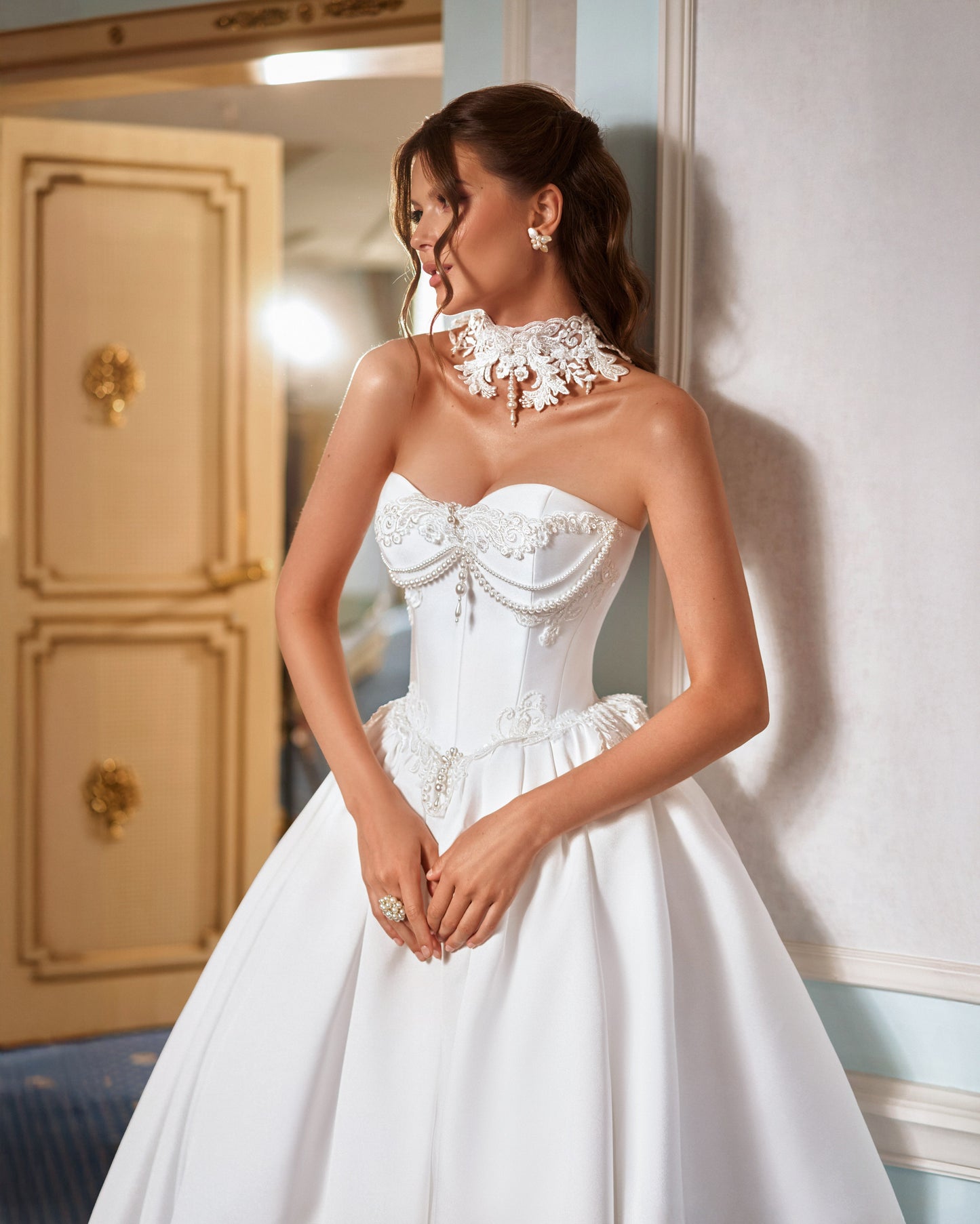 Strapless Mikado princess A-line wedding dress with sweetheart neckline, lace and pearl choker, lace-up closure, and chapel train.