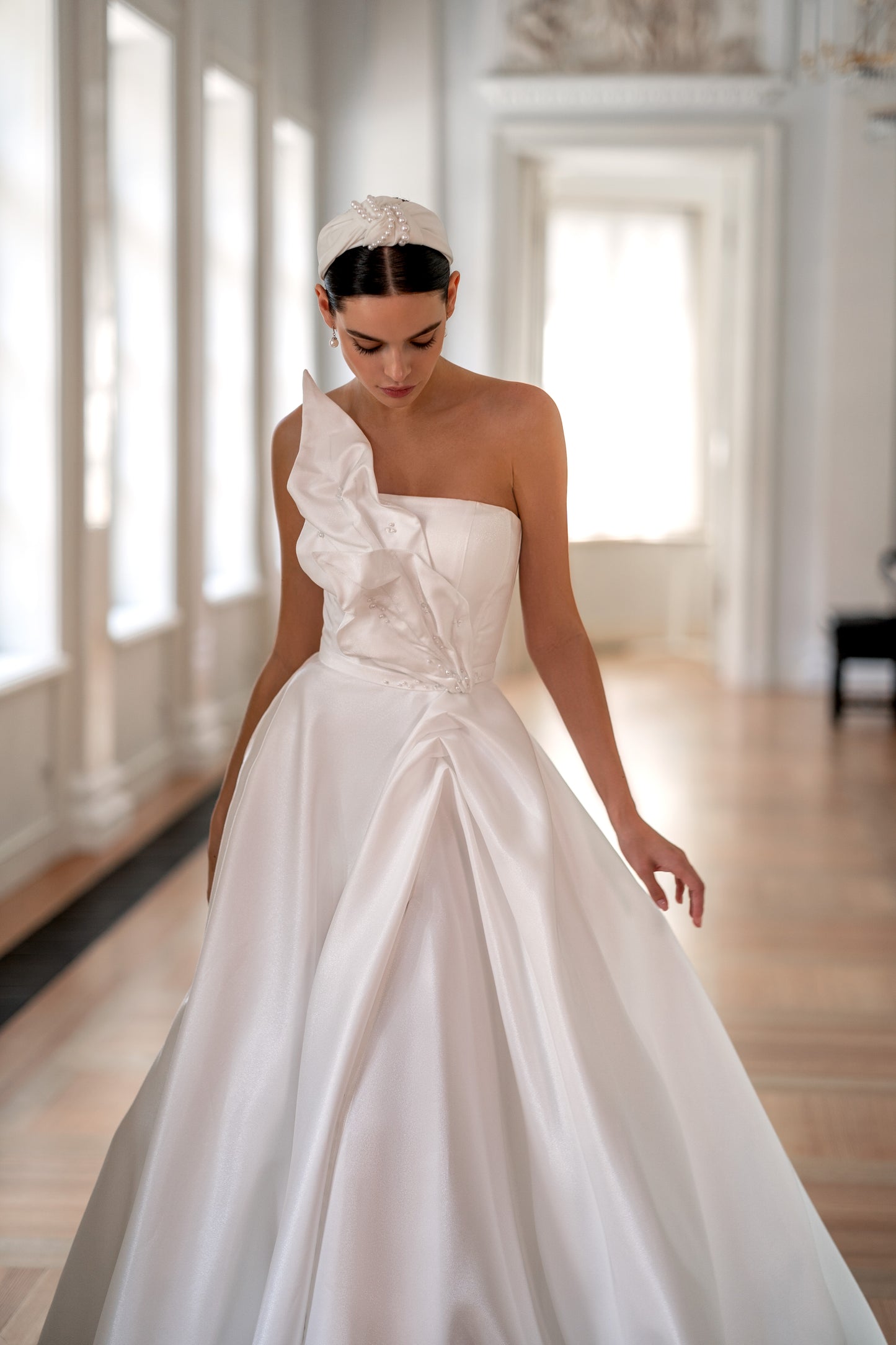 Strapless modest wedding dress with lace-up back and slit.