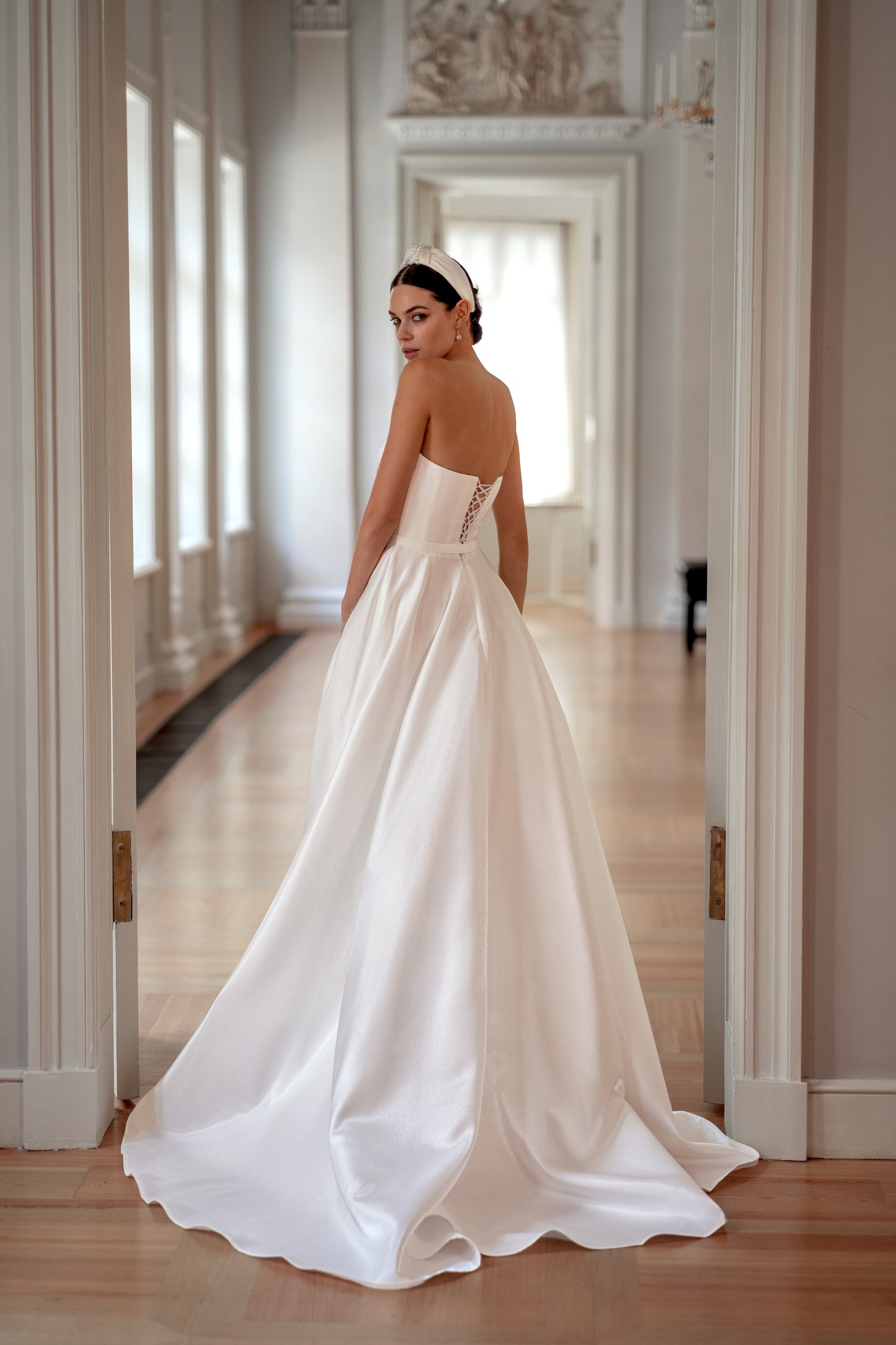 Strapless modest wedding dress with lace-up back and slit.