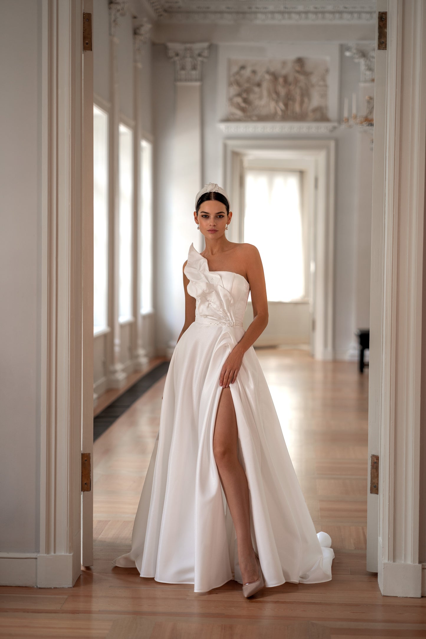 Strapless modest wedding dress with lace-up back and slit.