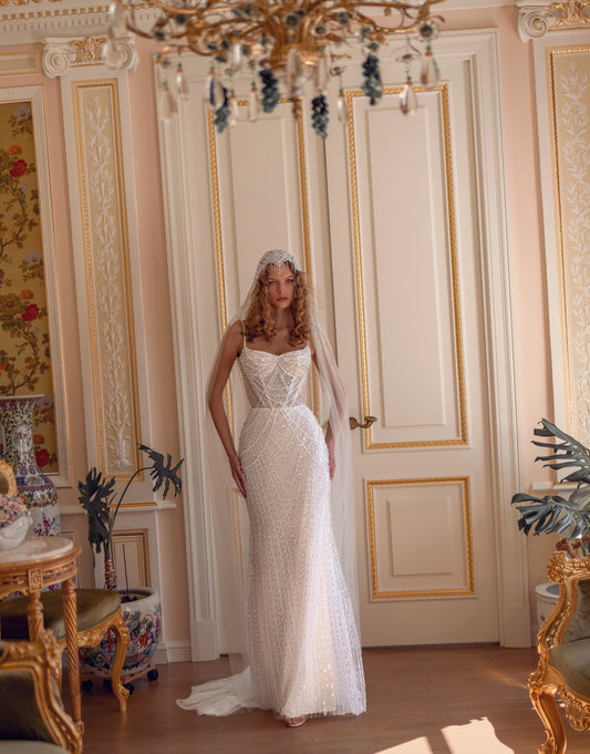 Beaded lace corset wedding gown with sweetheart neckline and chapel train, adorned with pearls and sequins.