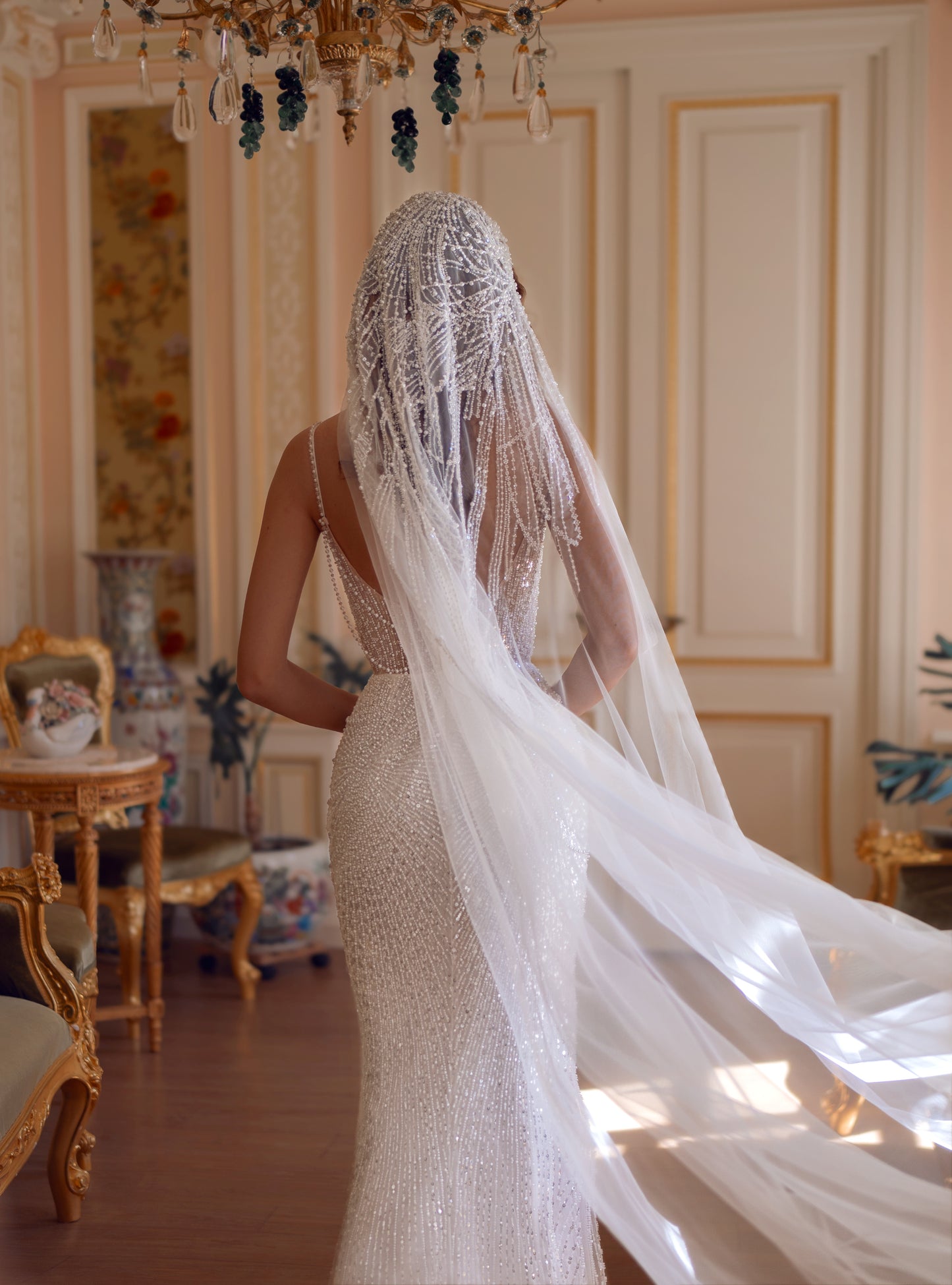 Beaded lace corset wedding gown with sweetheart neckline and chapel train, adorned with pearls and sequins.