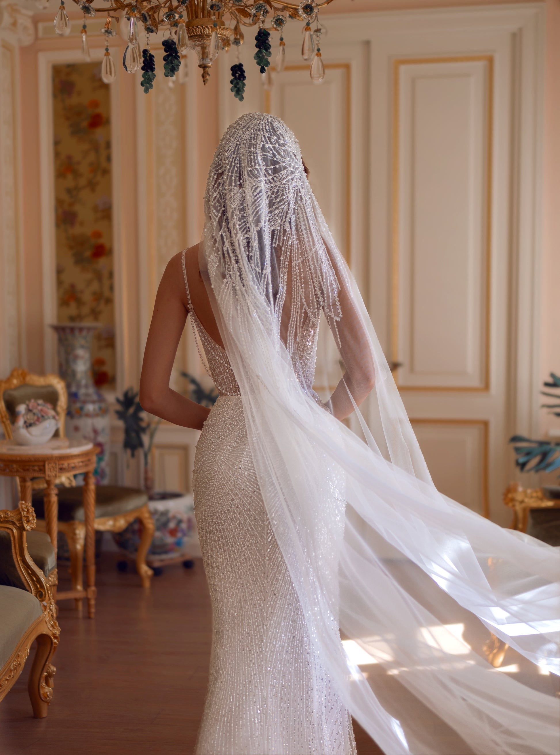 Beaded lace corset wedding gown with sweetheart neckline and chapel train, adorned with pearls and sequins.