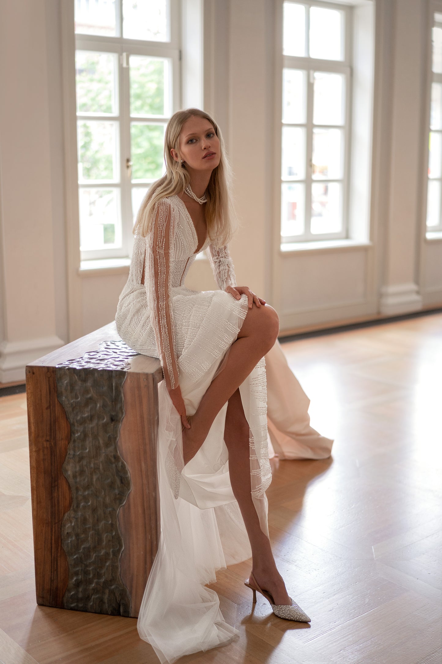 Elegant sheath silhouette bridal gown with illusion button-up back closure and sweep train.