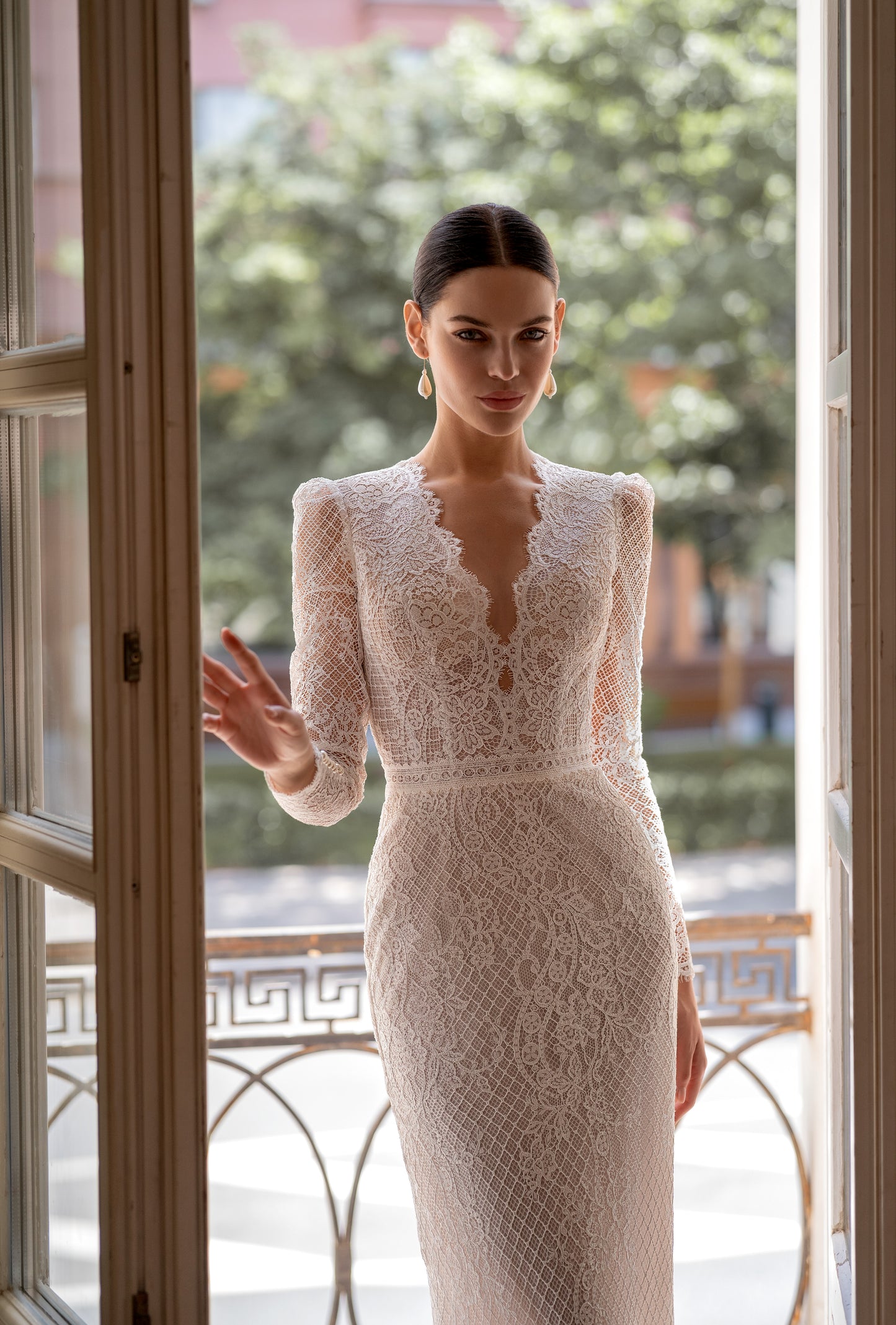 Mermaid wedding dress with lace, long sleeves, and open back