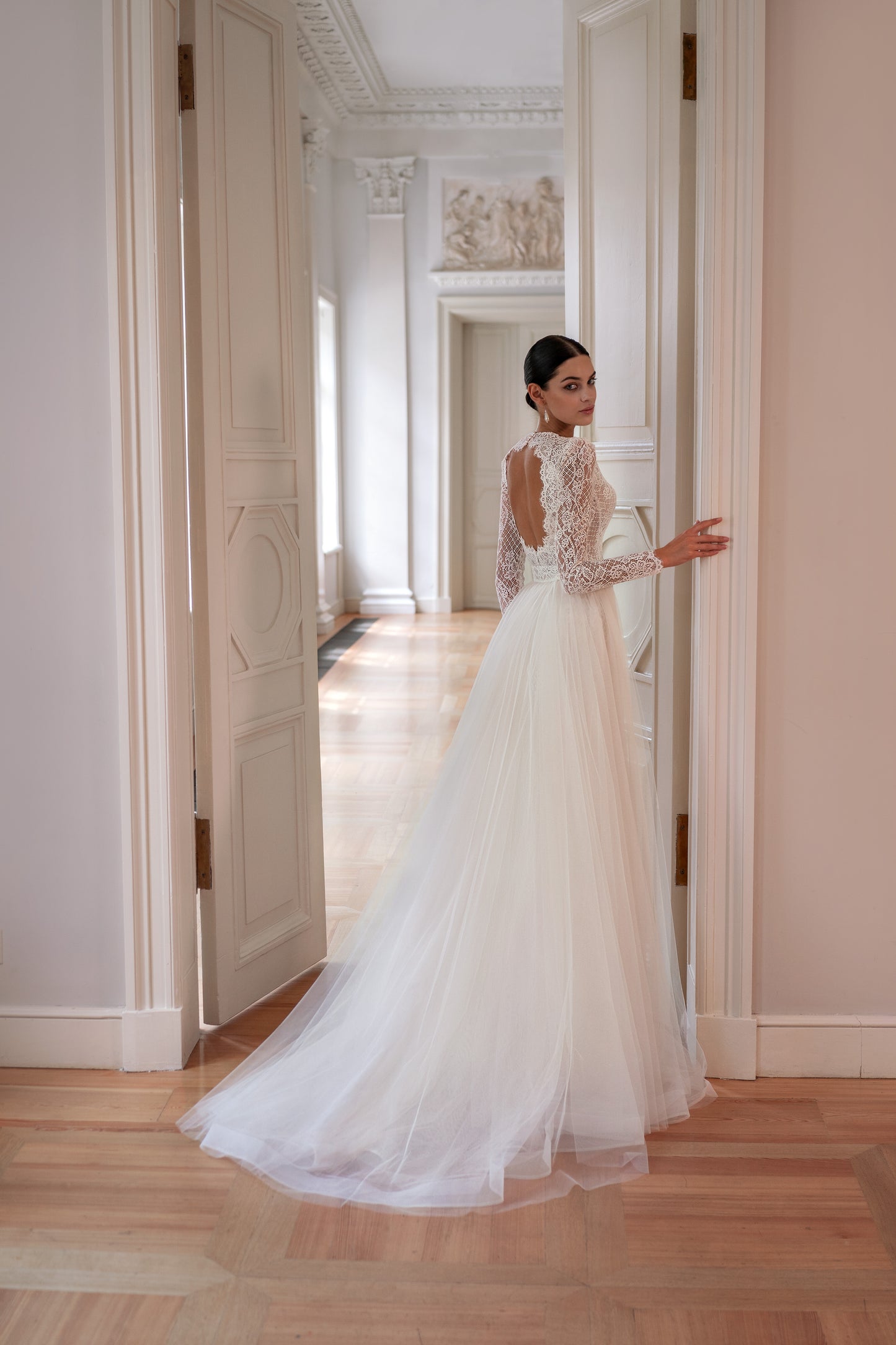 Mermaid wedding dress with lace, long sleeves, and open back