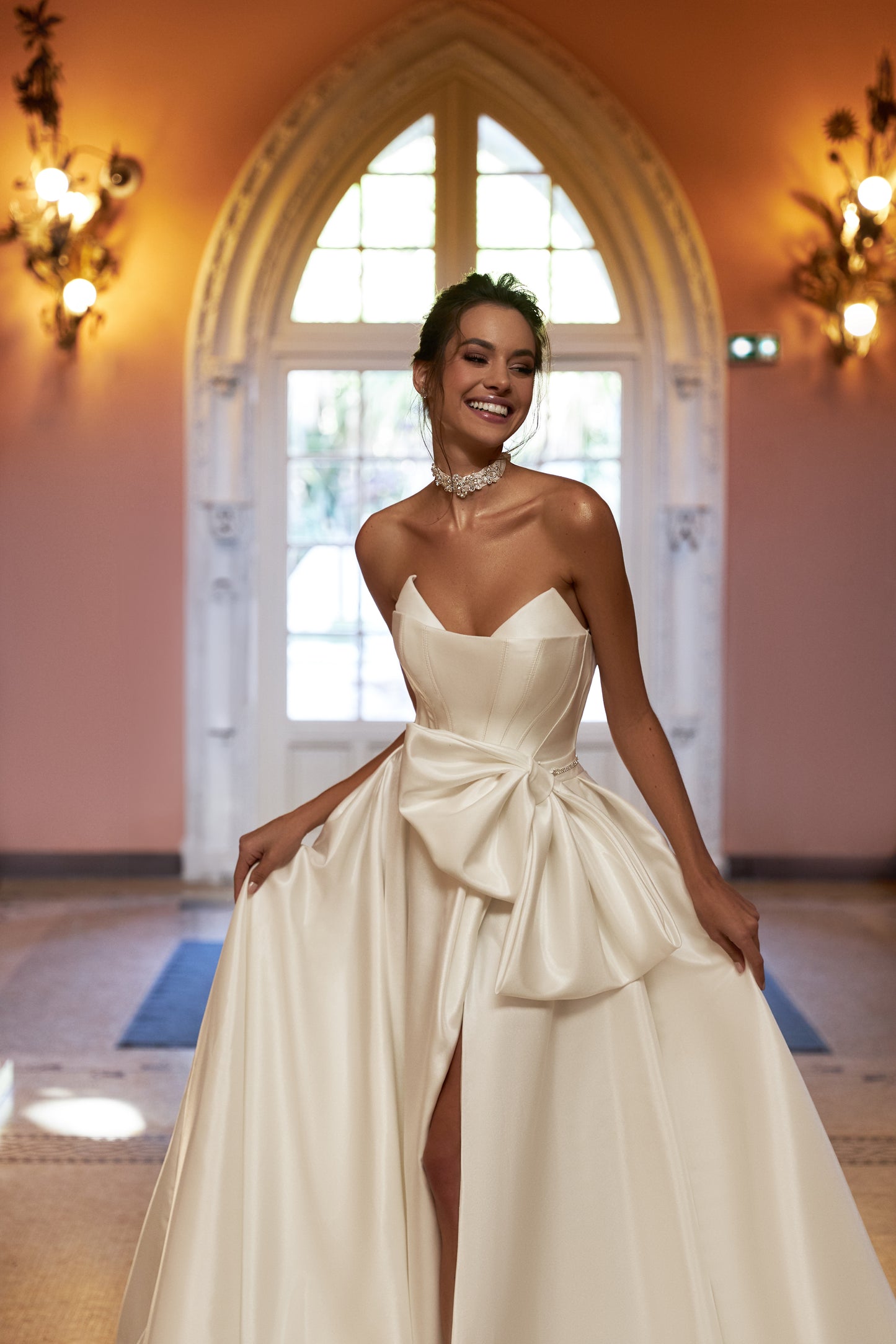 Ivory A-line sleeveless wedding dress with open back & bow.