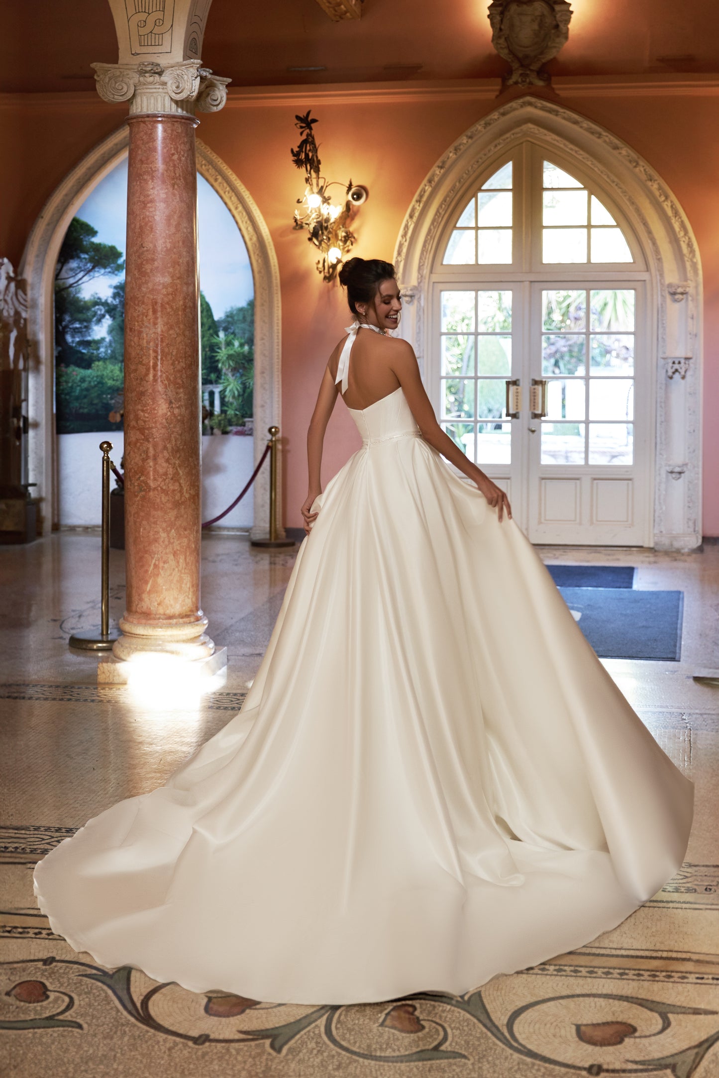 Ivory A-line sleeveless wedding dress with open back & bow.