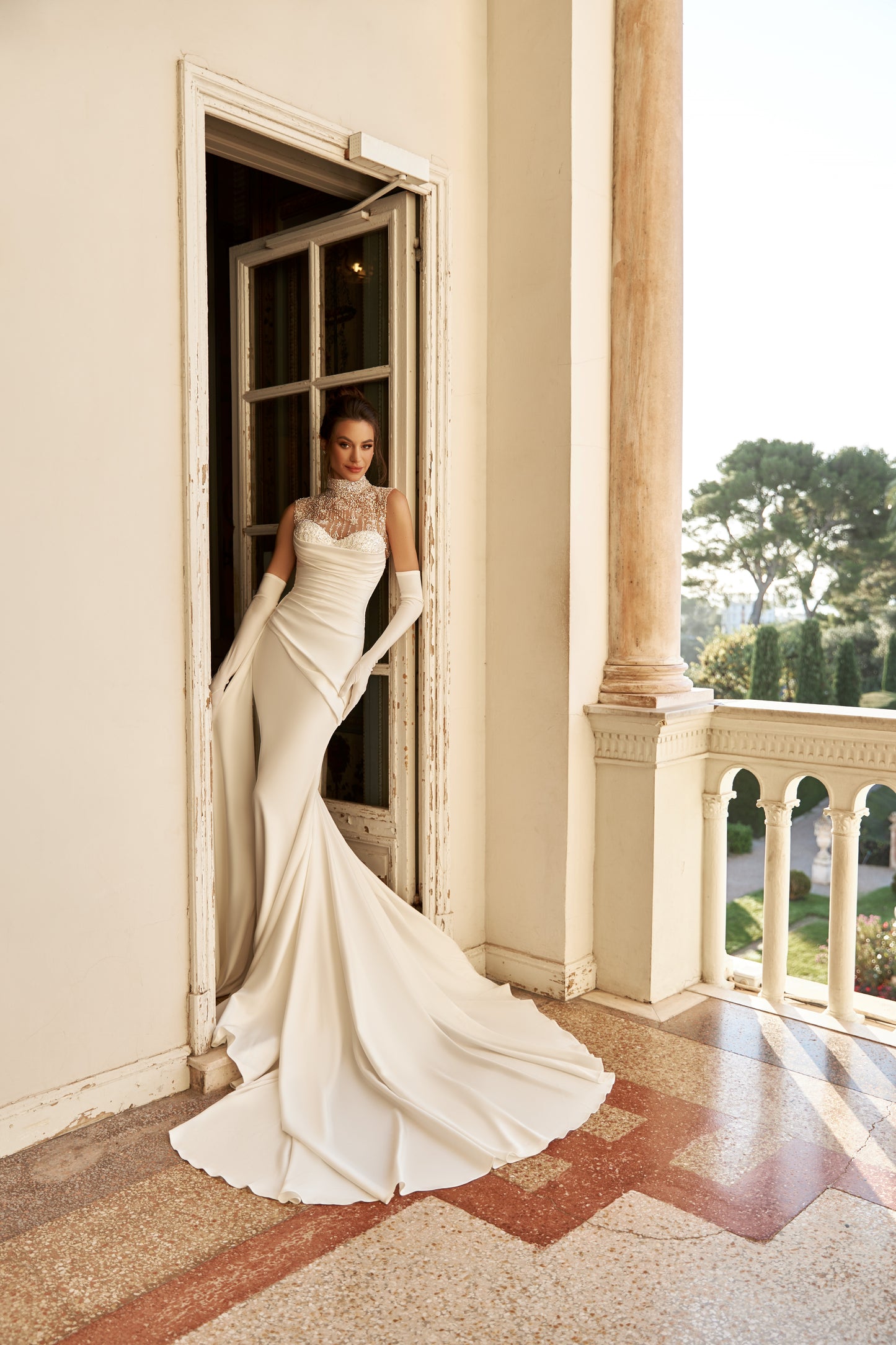 Fitted satin mermaid wedding dress with fishtail train.