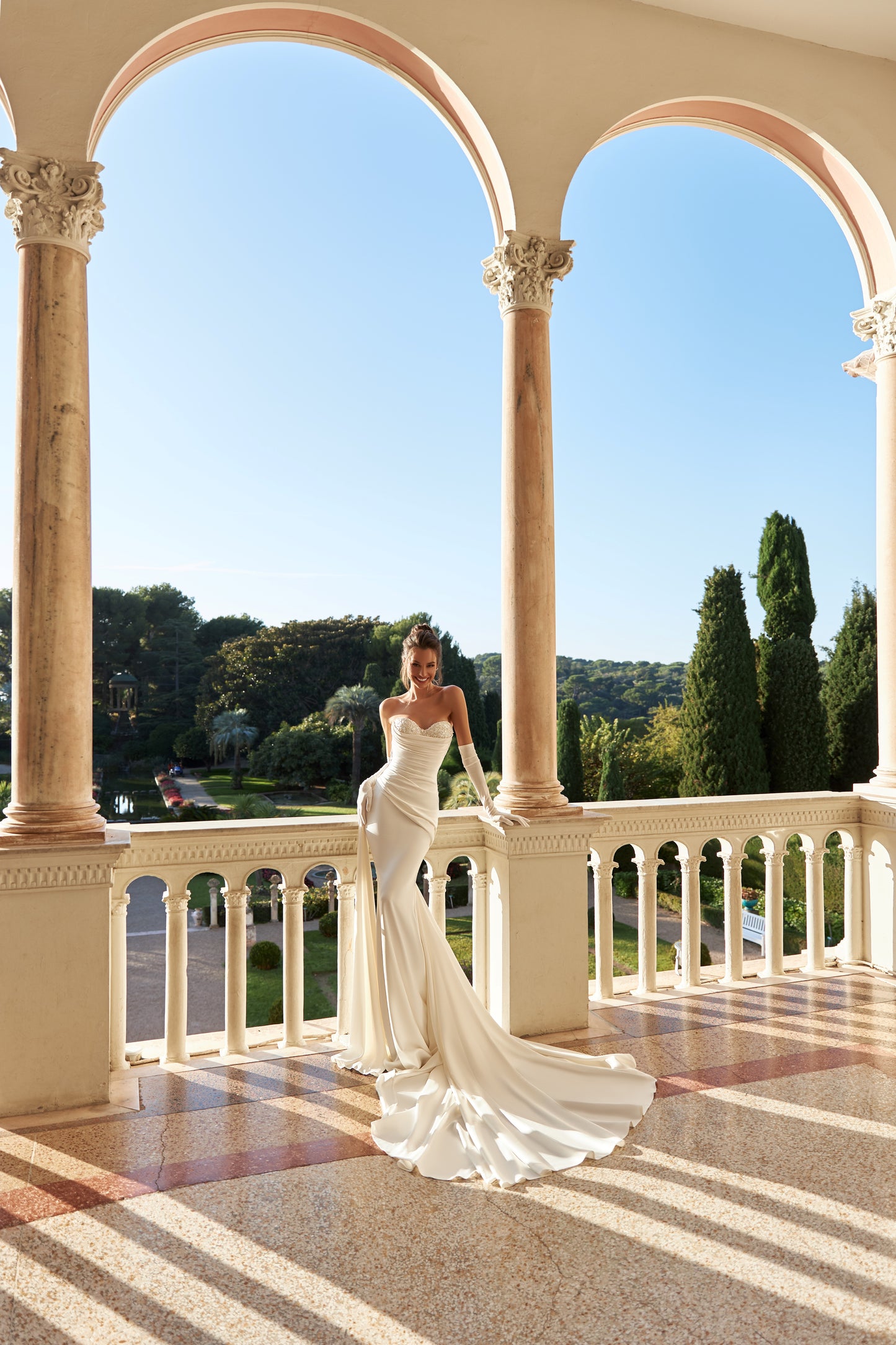 Fitted satin mermaid wedding dress with fishtail train.