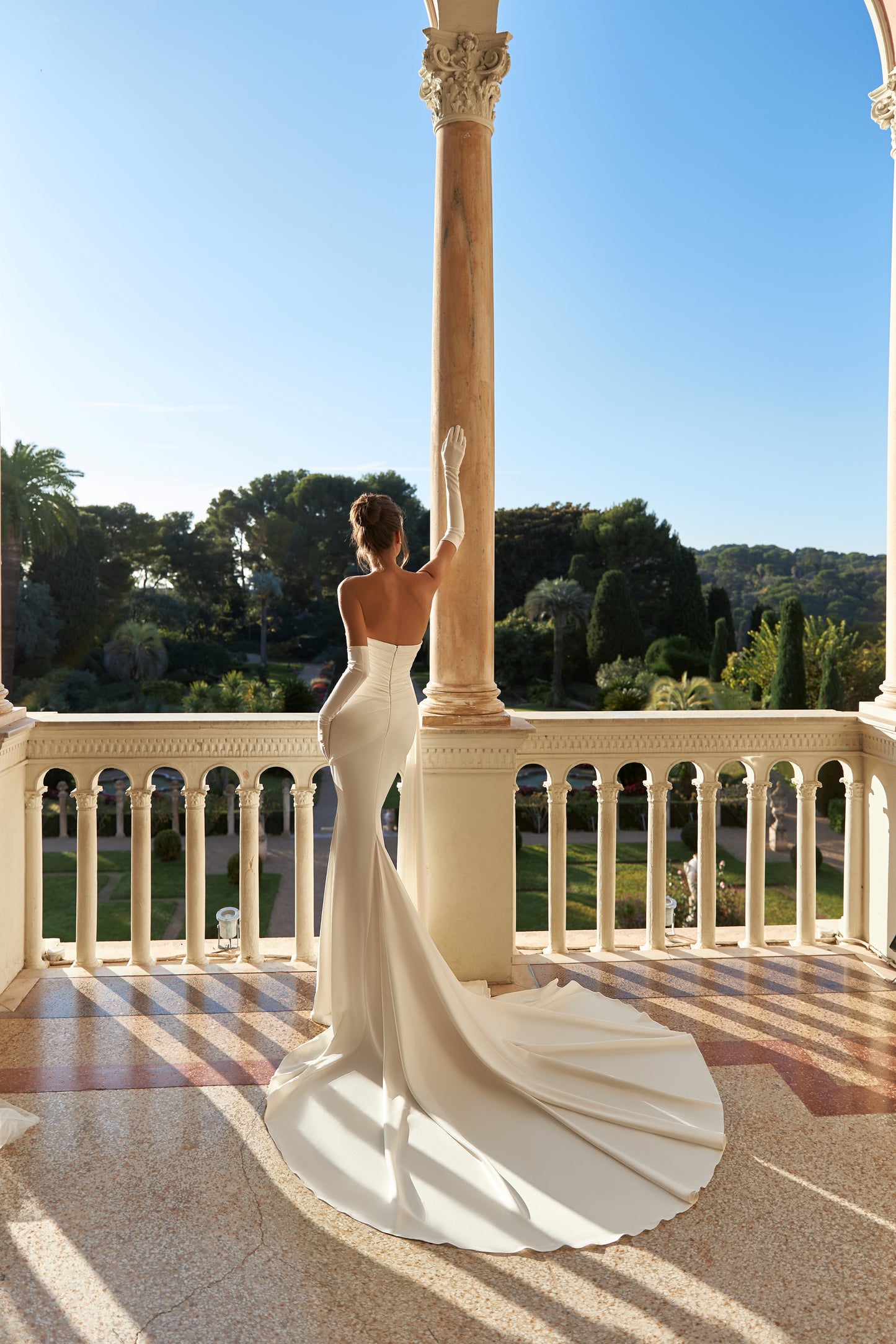 Fitted satin mermaid wedding dress with fishtail train.