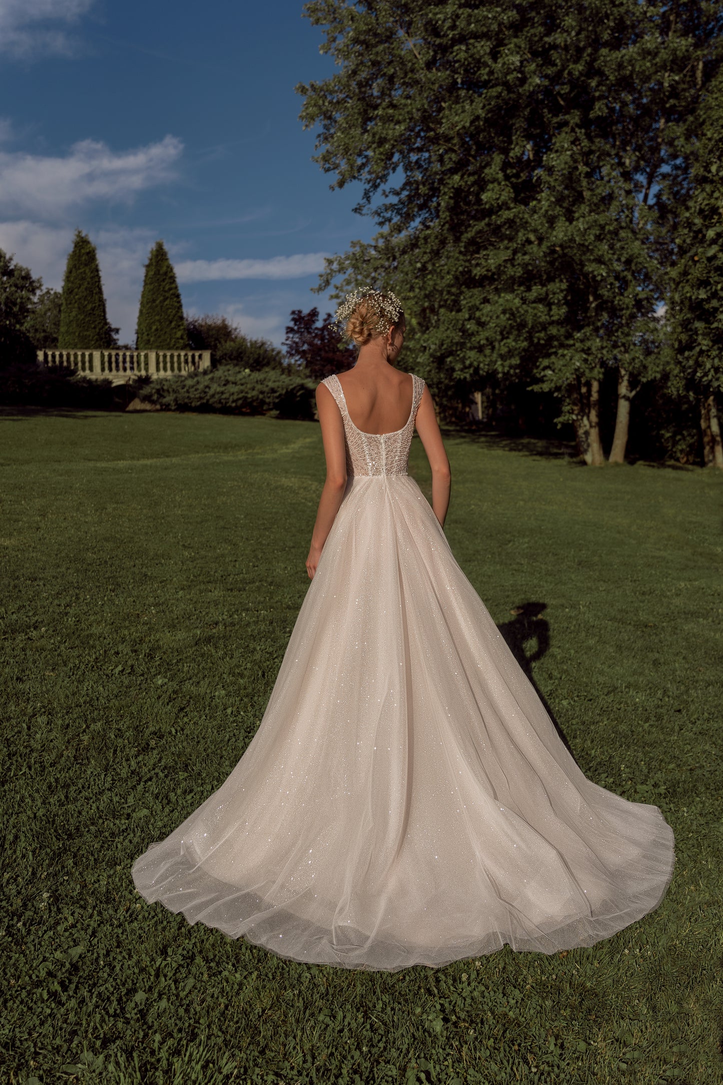 Sleeveless A-line wedding dress with open back & court train