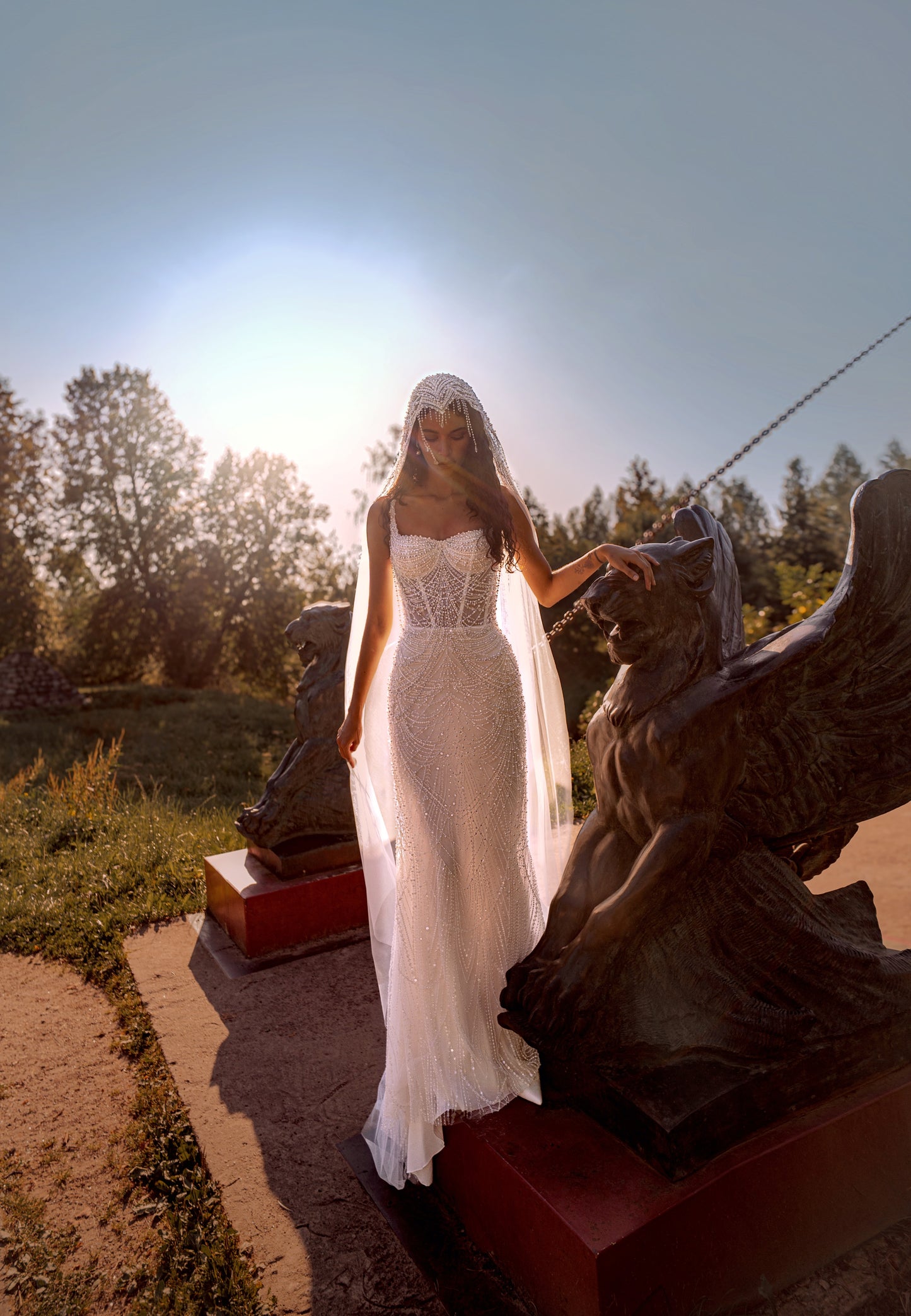 Beaded mermaid wedding gown with geometric pearl embroidery, sheer corset bodice, and elegant train.