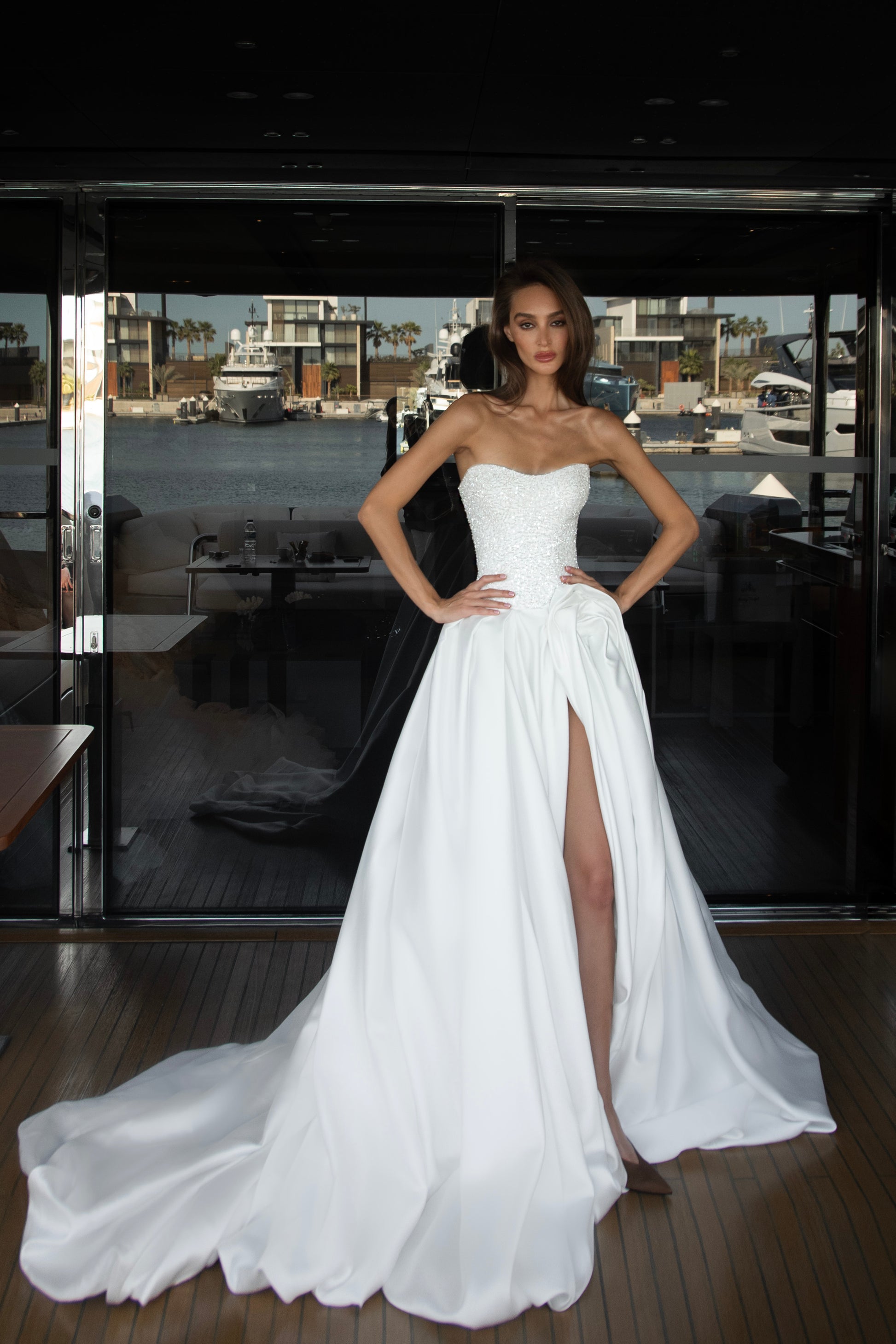 Mikado wedding gown with beaded lace corset, strapless neckline, and high slit.