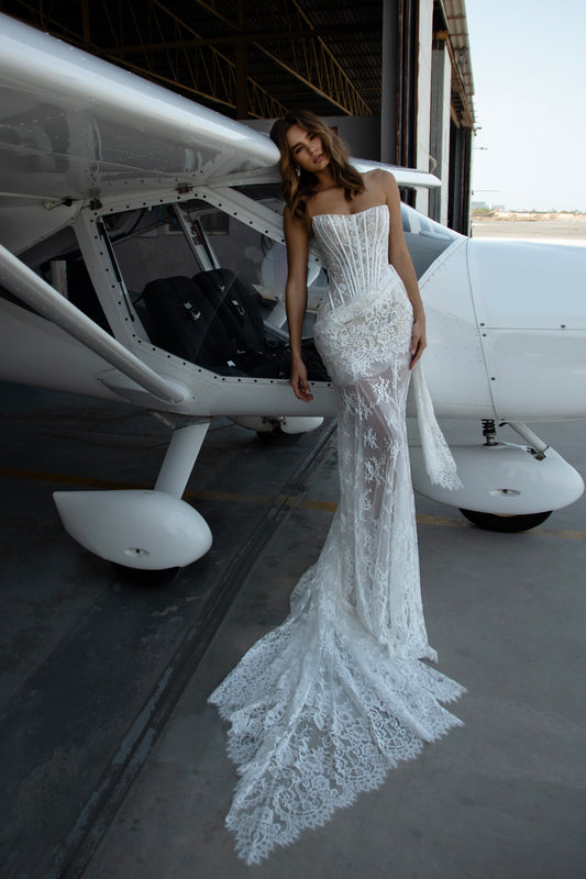 Three-piece lace transformer wedding dress featuring structured corset, fitted underskirt, detachable lace overskirt, sleeveless straight neckline, and column silhouette