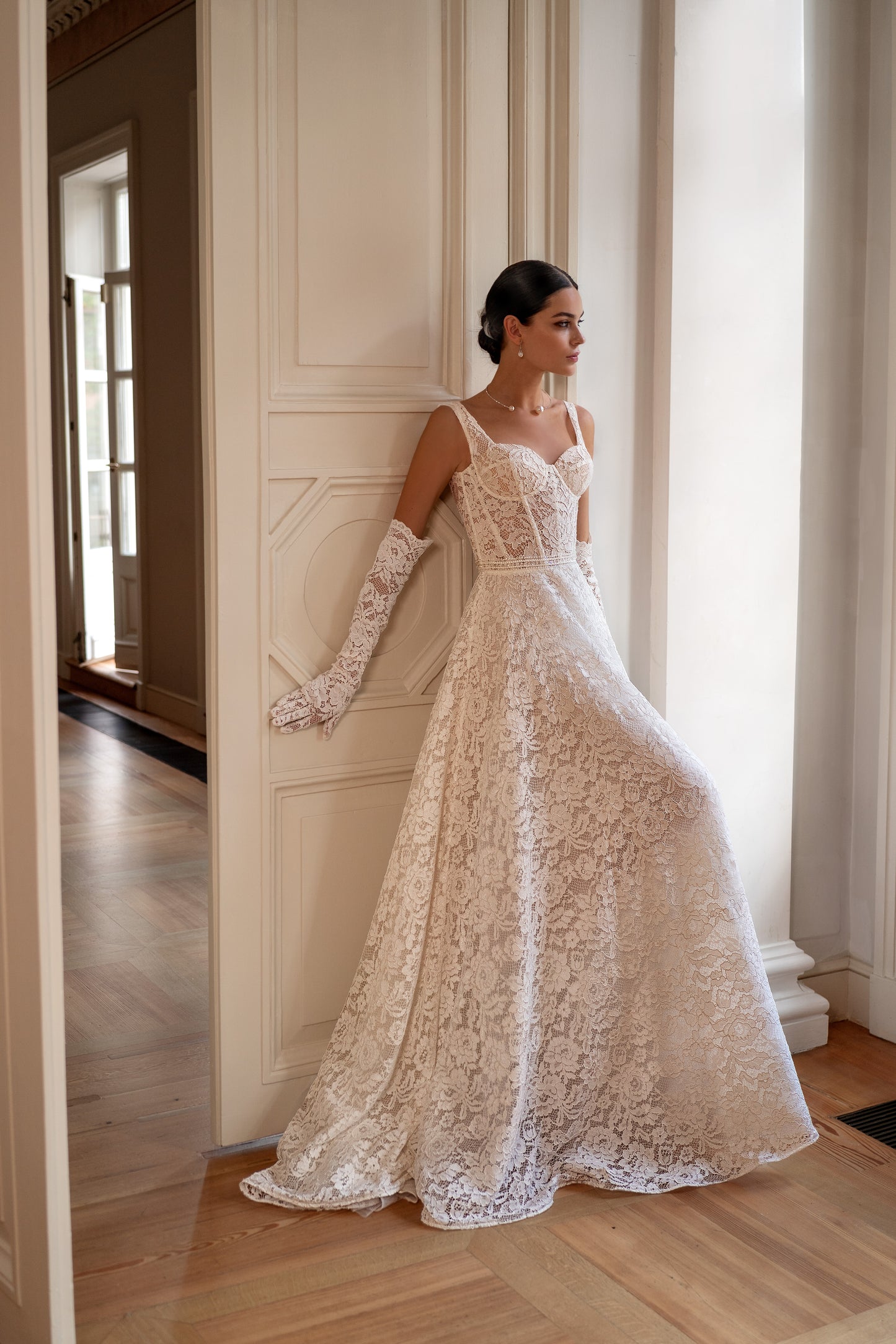 Sleeveless lace A-line wedding dress with open back and court train