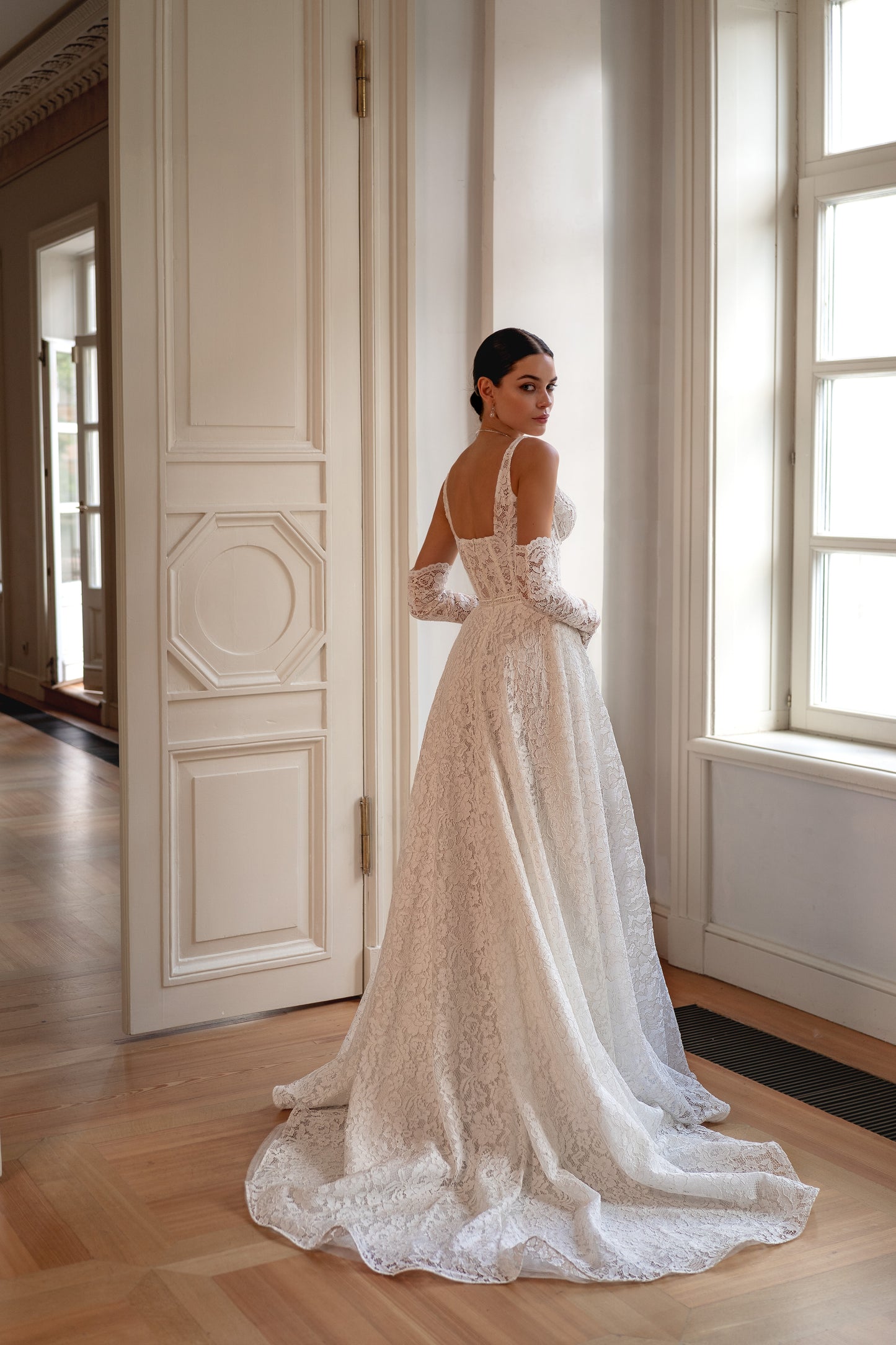 Sleeveless lace A-line wedding dress with open back and court train