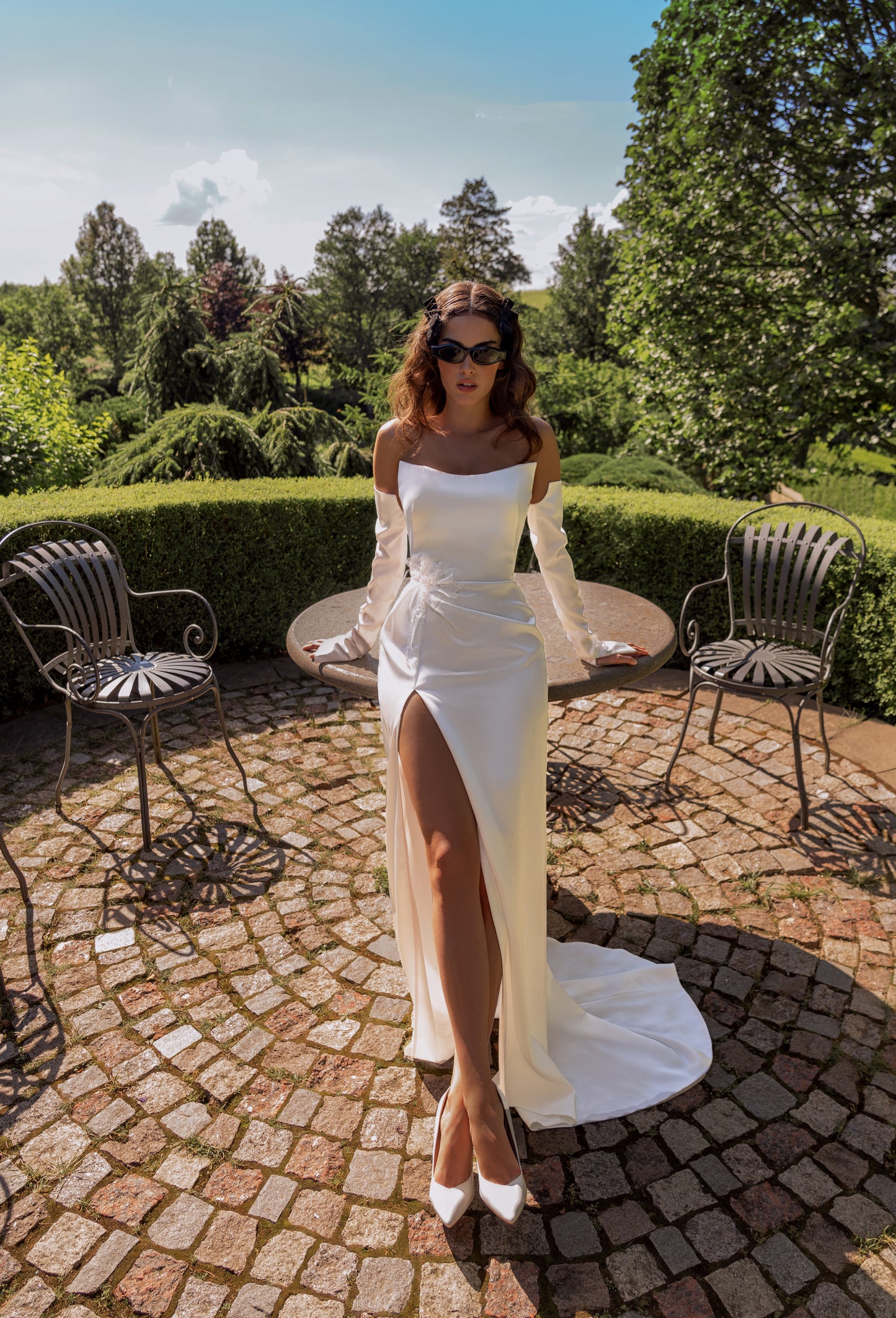 Sheath modest wedding dress with boat neckline & slit skirt.