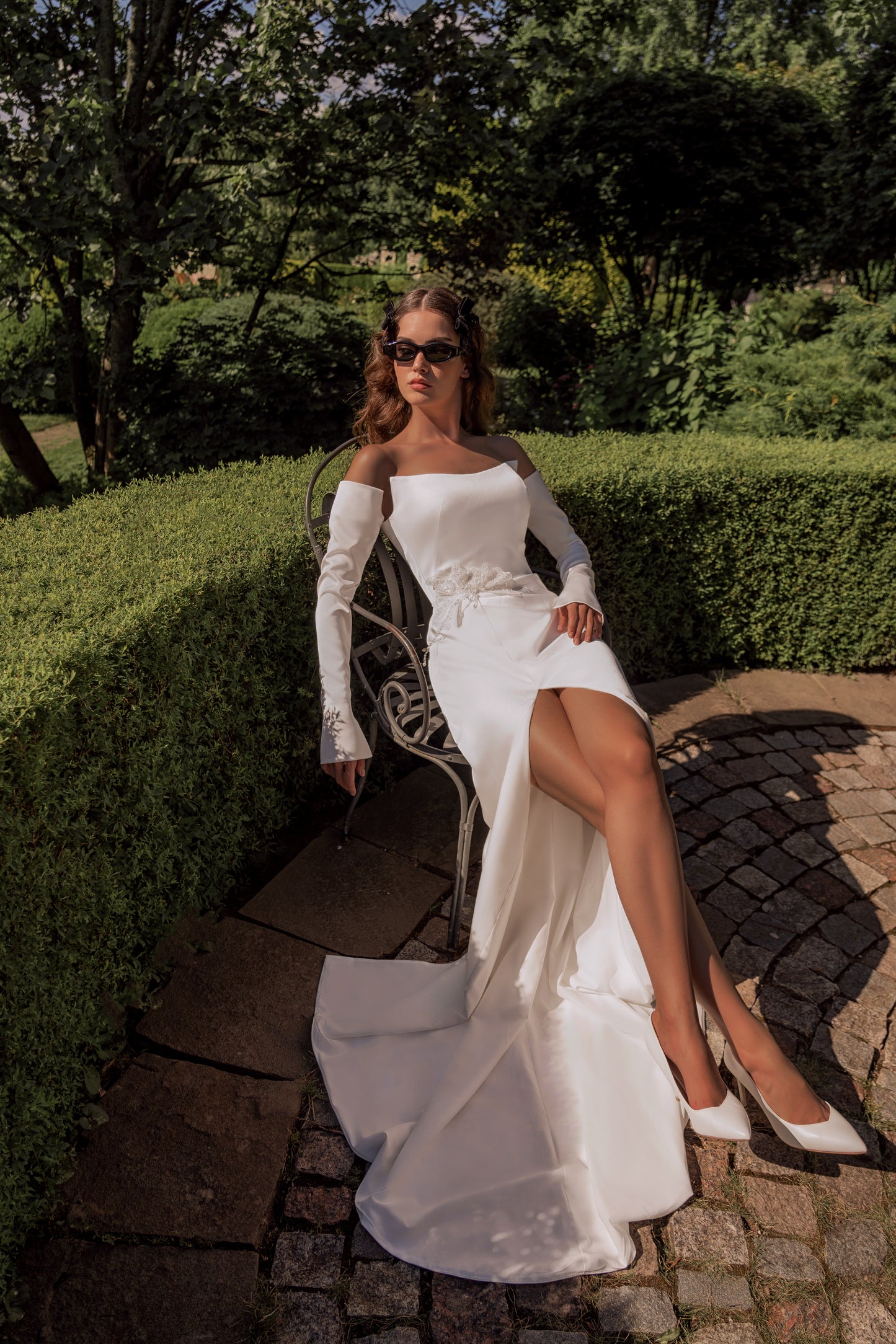 Sheath modest wedding dress with boat neckline & slit skirt.