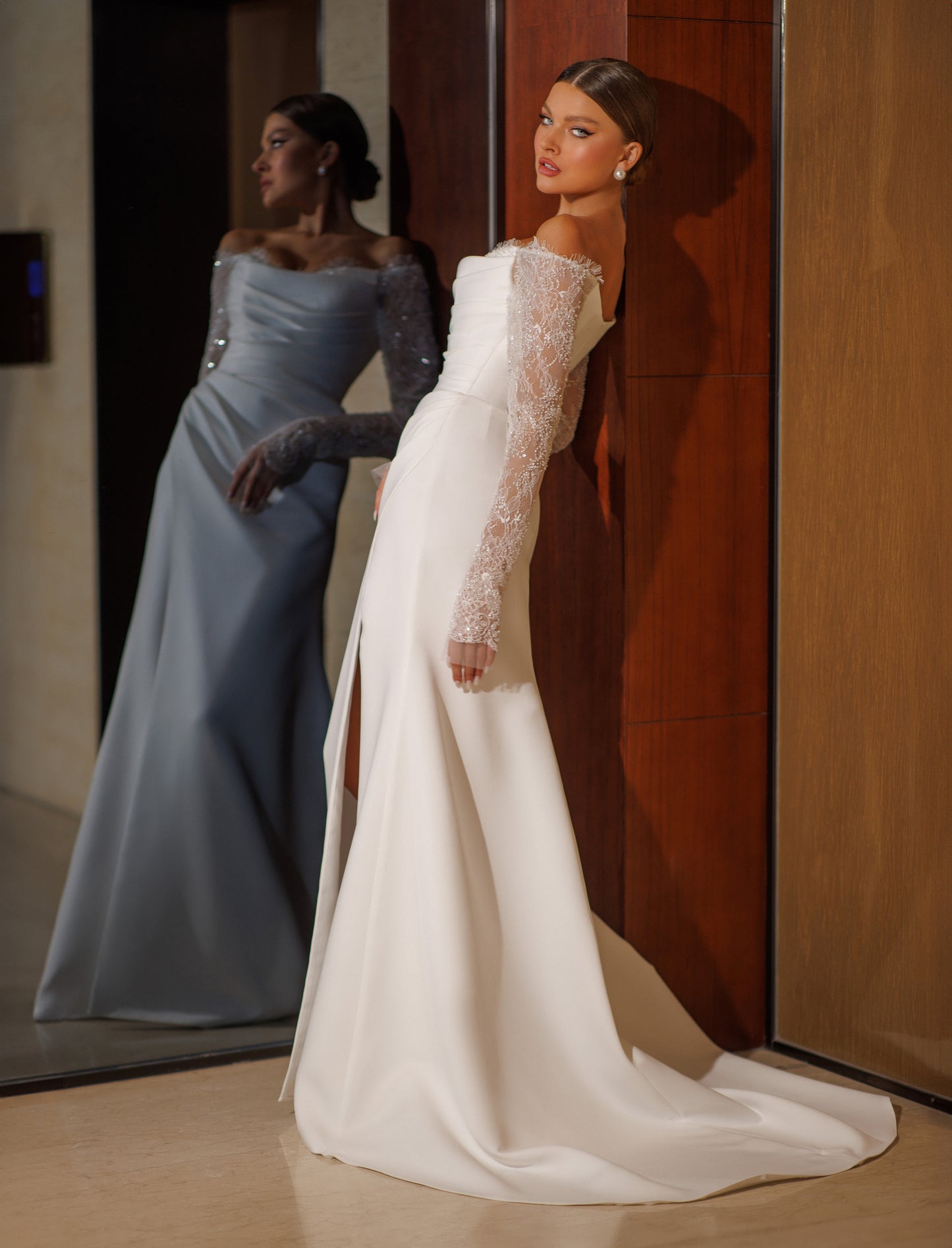 Fitted sheath wedding dress with long illusion lace sleeves.