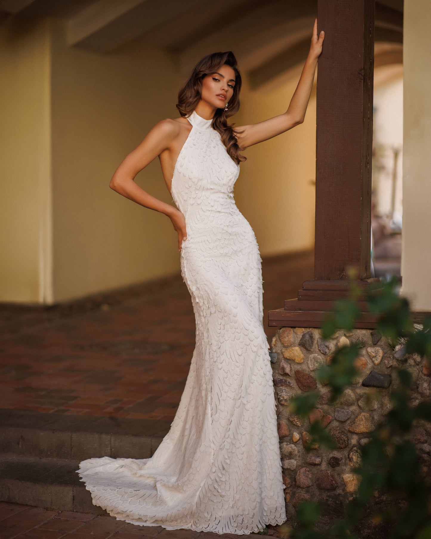 Backless fitted chiffon wedding dress with mockneck & sweep.