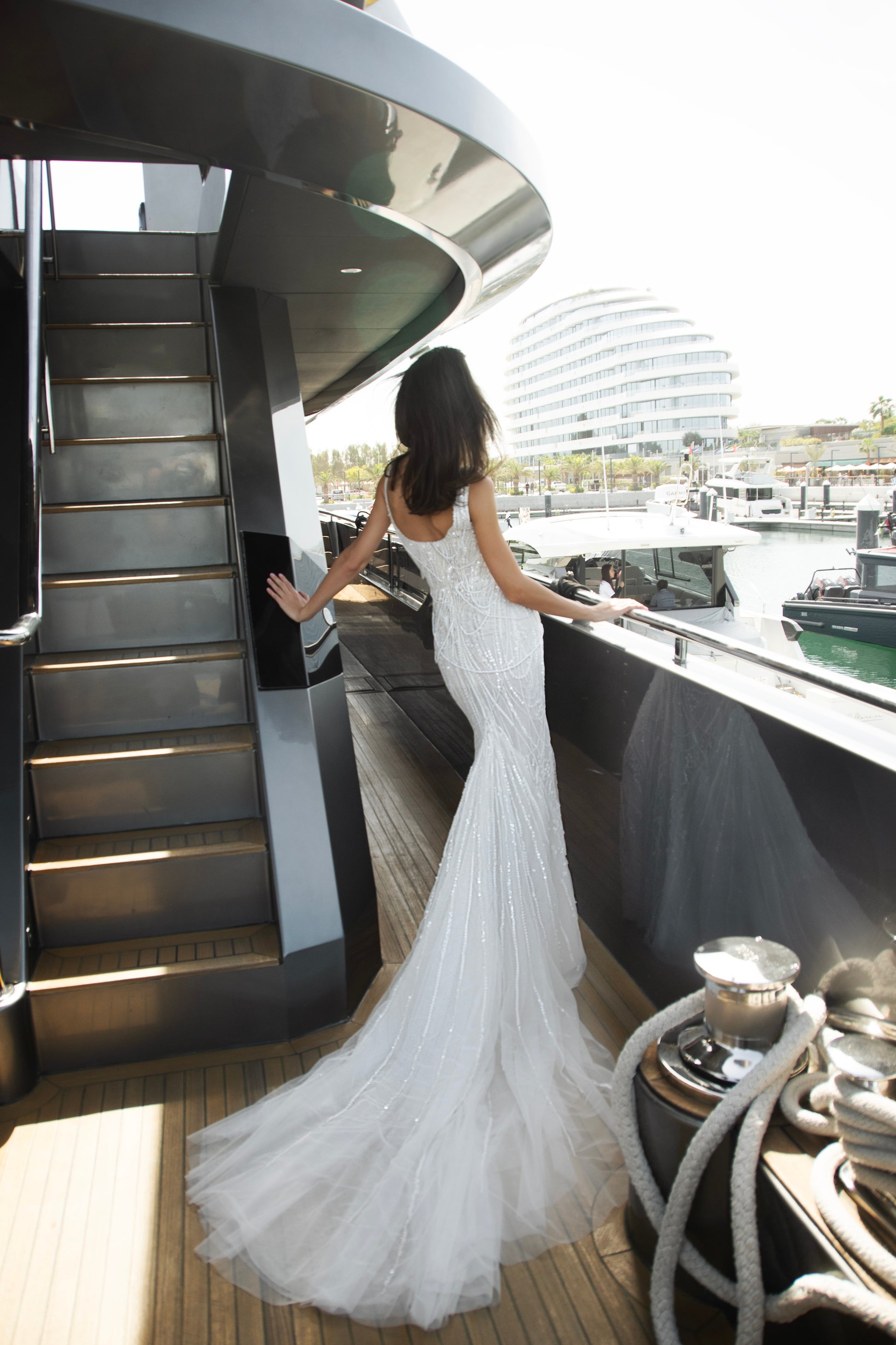 Sculpted beaded mermaid wedding gown with scoop neckline, pearl-inspired detailing, and soft tulle chapel train.