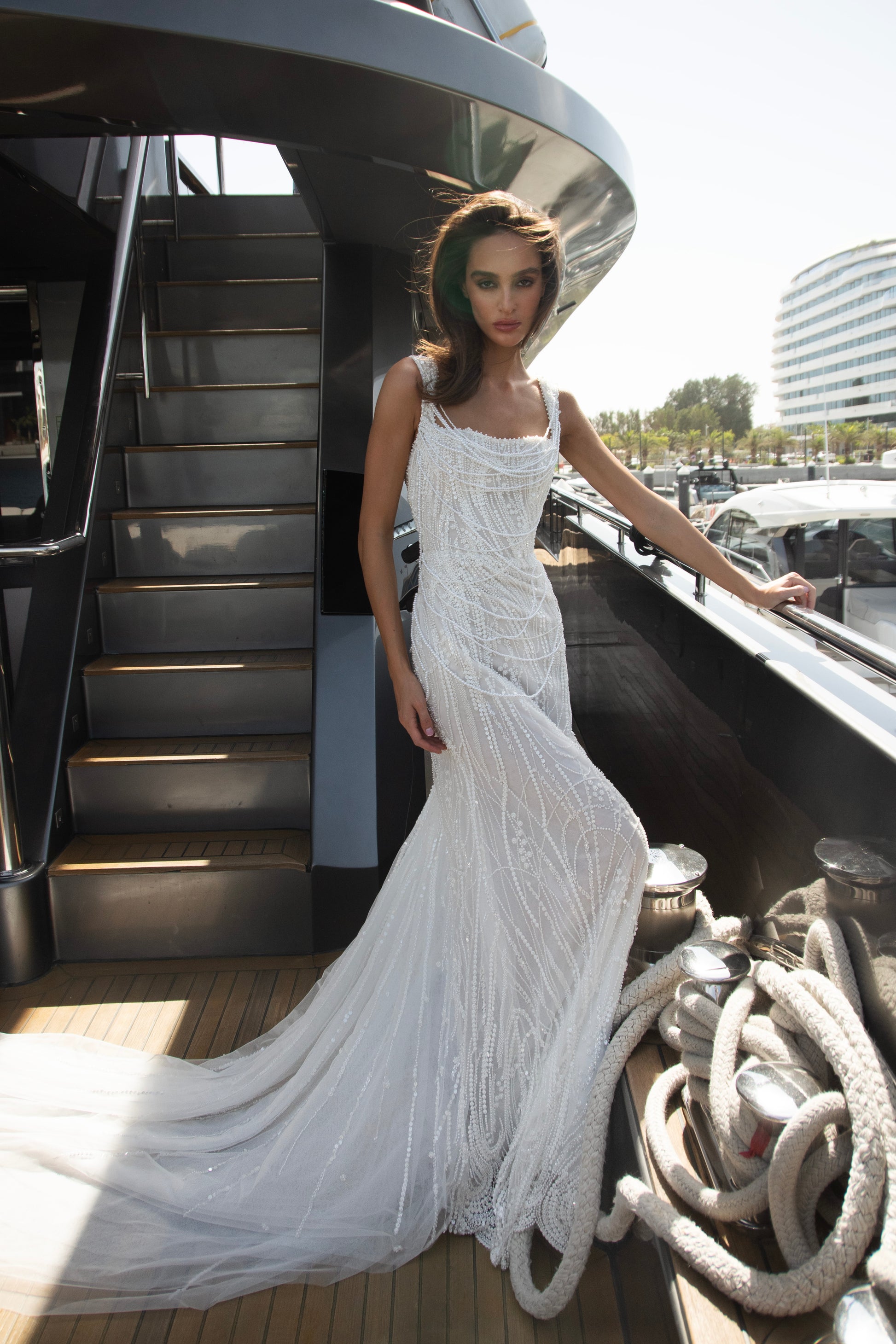 Sculpted beaded mermaid wedding gown with scoop neckline, pearl-inspired detailing, and soft tulle chapel train.