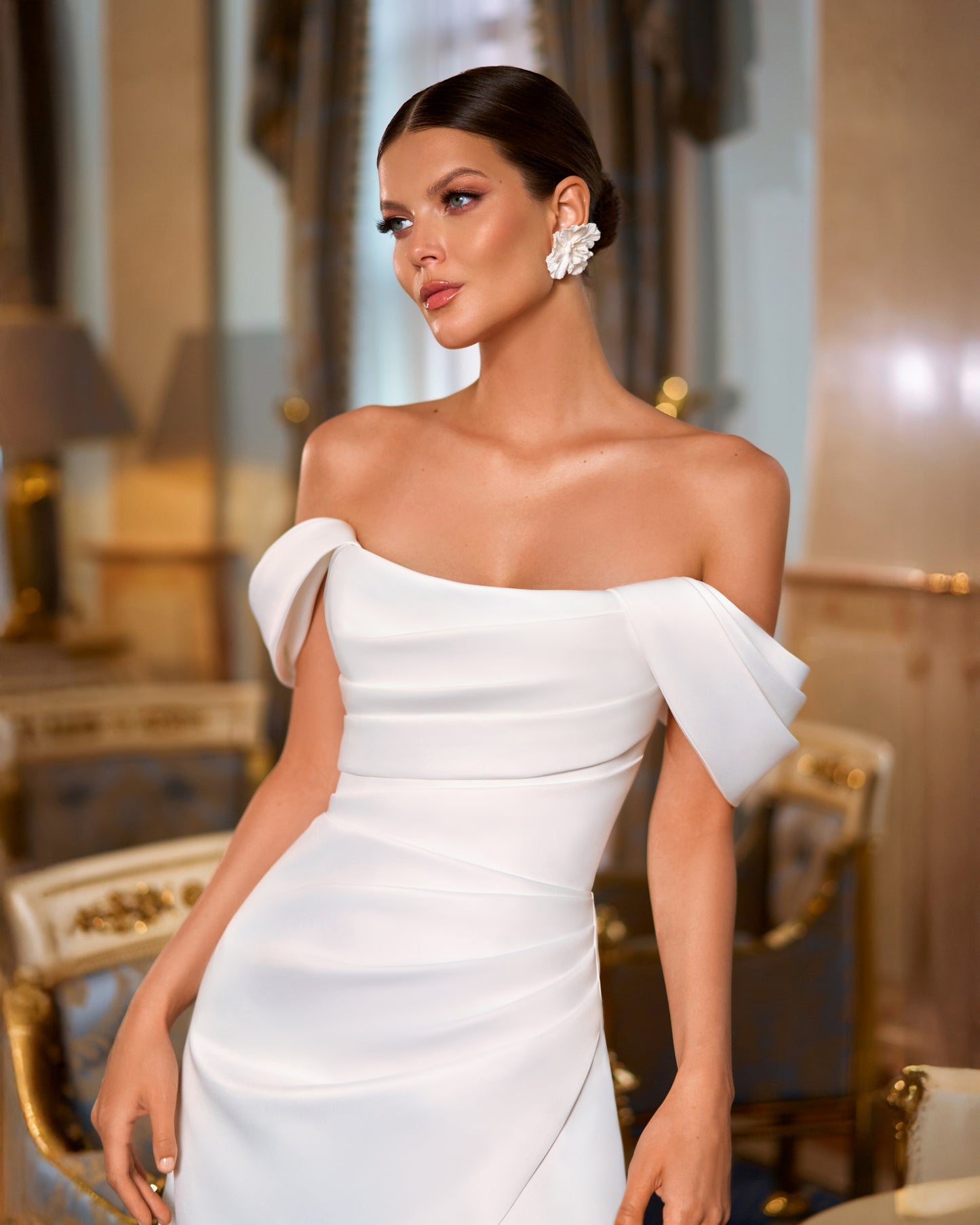 Mikado A-line minimalist wedding dress with off-the-shoulder boat neckline, draped bodice, slit skirt, and sweeping chapel train for modern elegant bridal look