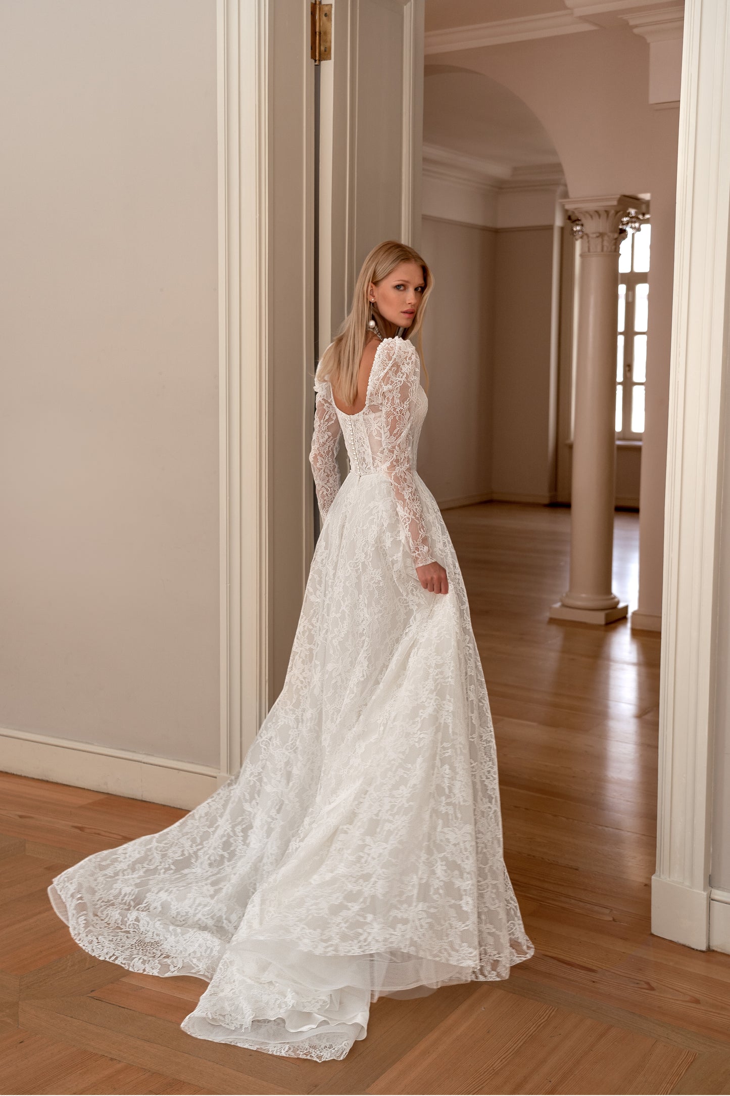 A-line wedding dress with long sleeves and open back.