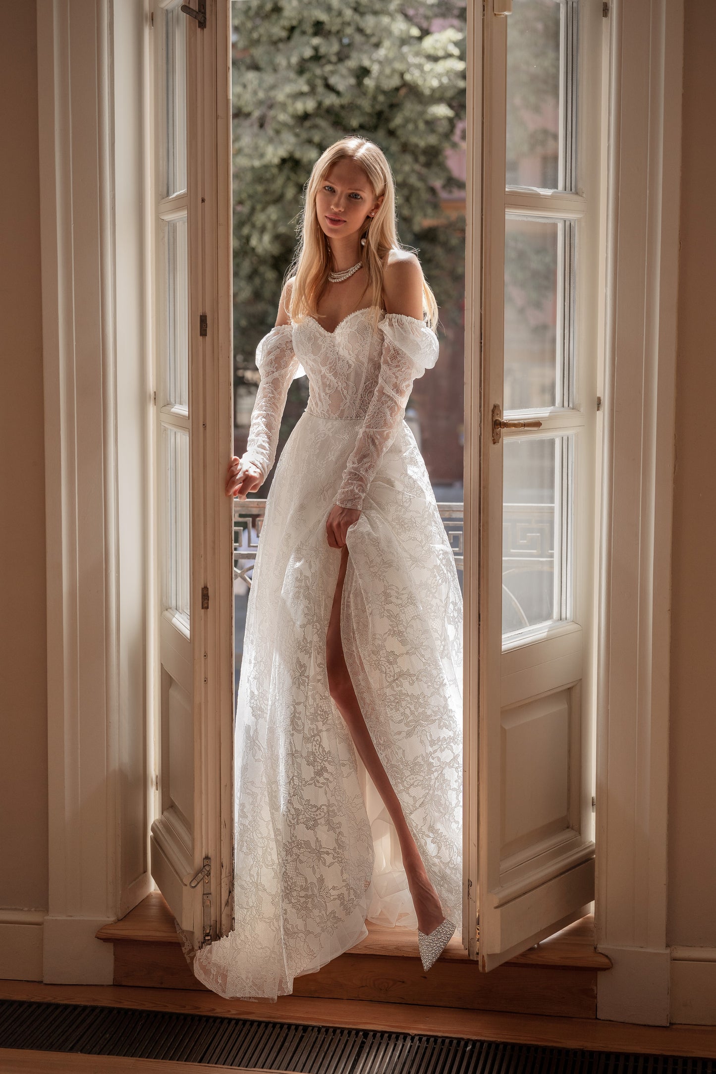 A-line wedding dress with long sleeves and open back.
