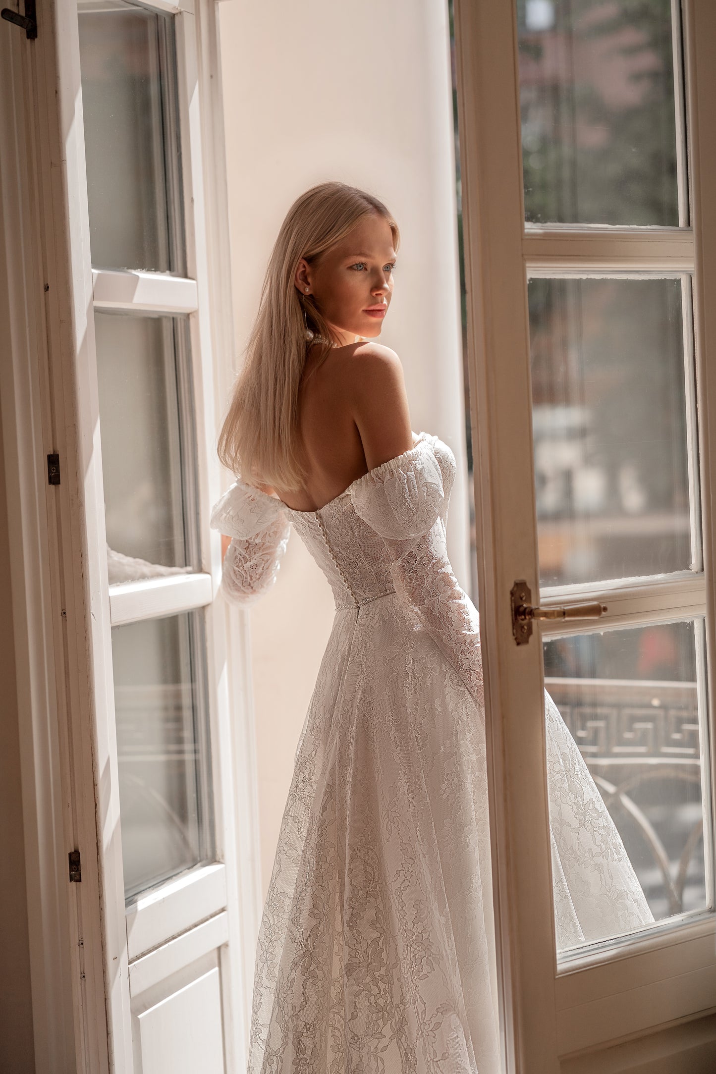 A-line wedding dress with long sleeves and open back.