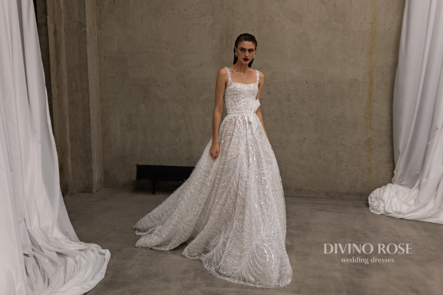 Sleeveless wedding dress with chapel train and sequin lace.