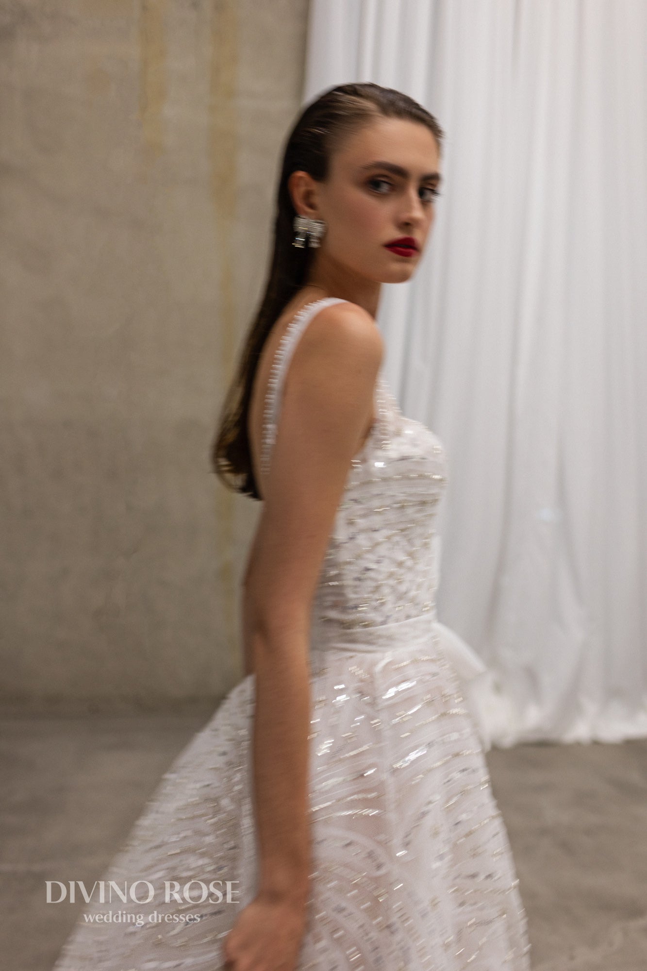 Sleeveless wedding dress with chapel train and sequin lace.