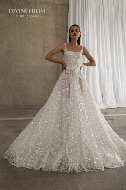 Sleeveless wedding dress with chapel train and sequin lace.
