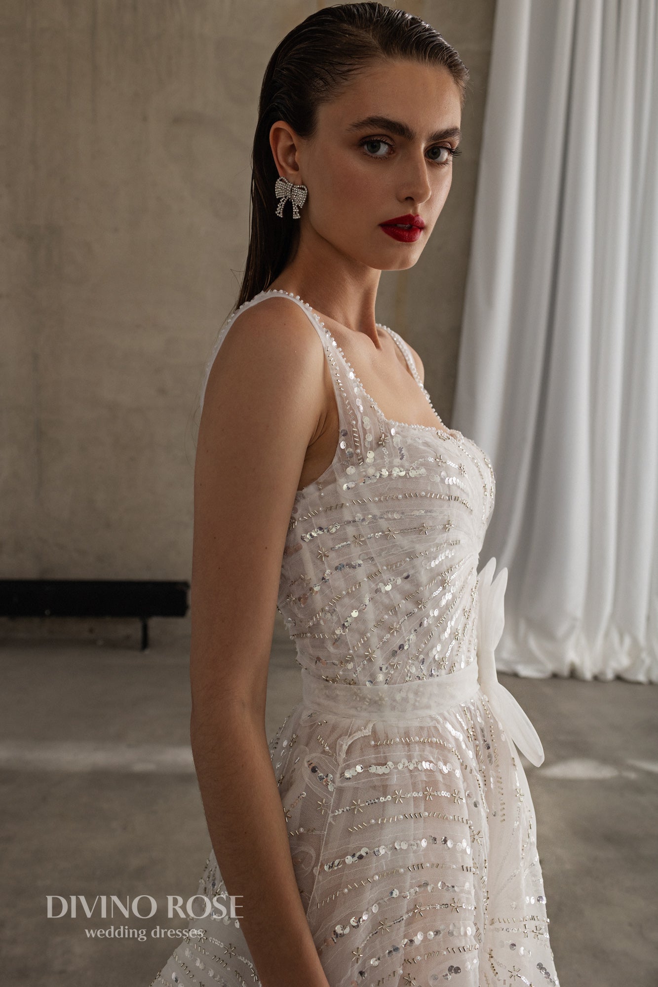 Sleeveless wedding dress with chapel train and sequin lace.