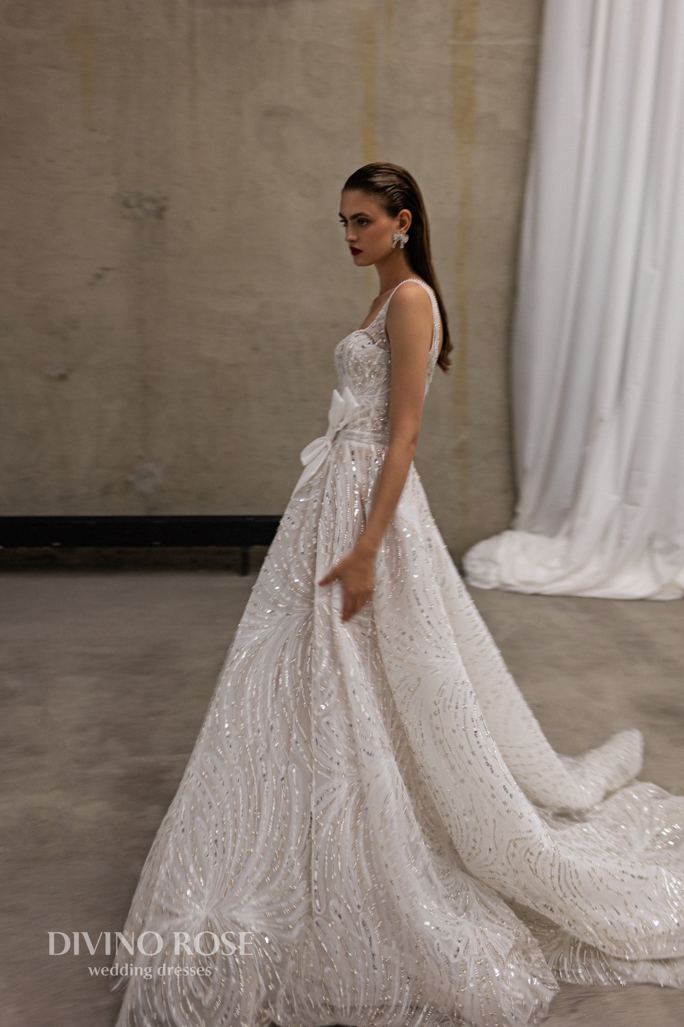 Sleeveless wedding dress with chapel train and sequin lace.