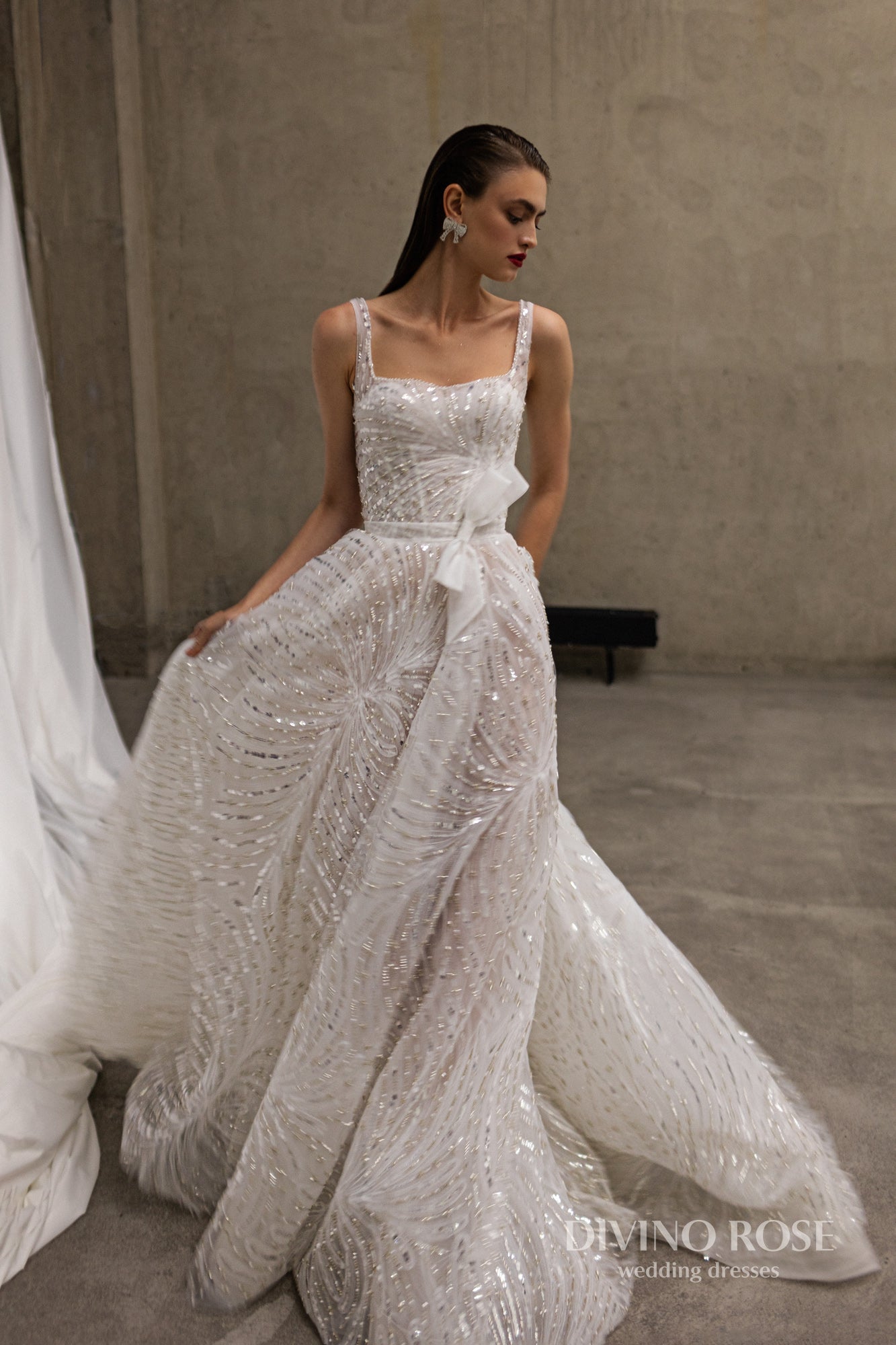 Sleeveless wedding dress with chapel train and sequin lace.