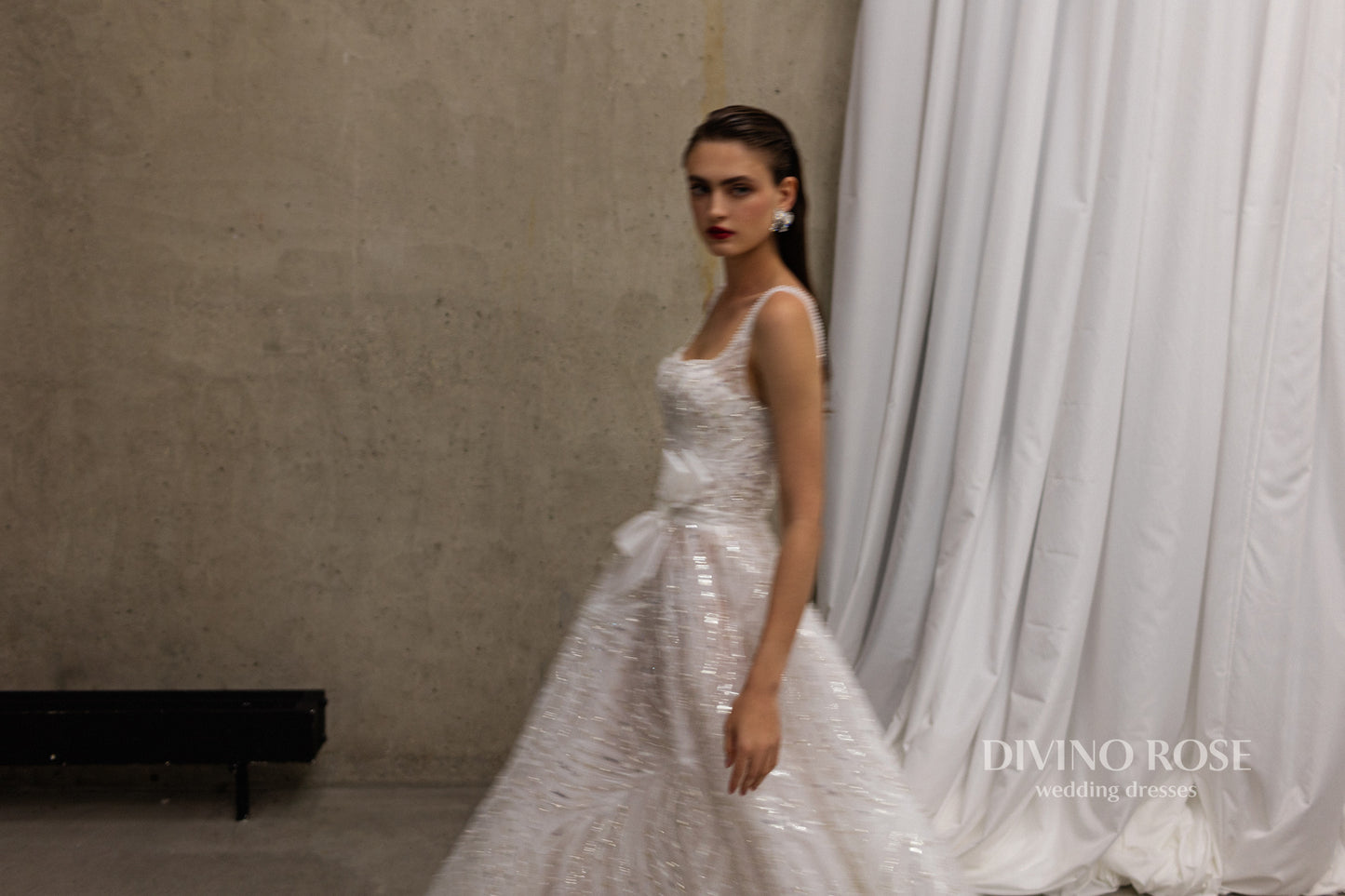 Sleeveless wedding dress with chapel train and sequin lace.