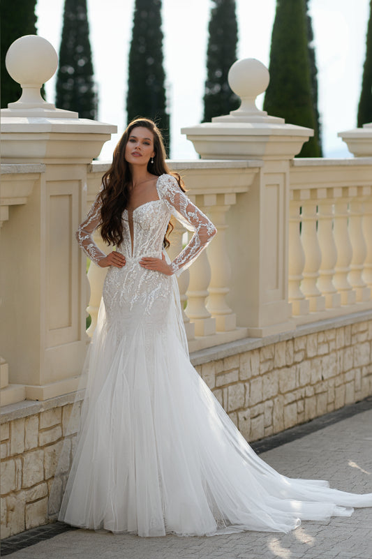 Mermaid wedding dress with long sleeves, bow, and fishtail train