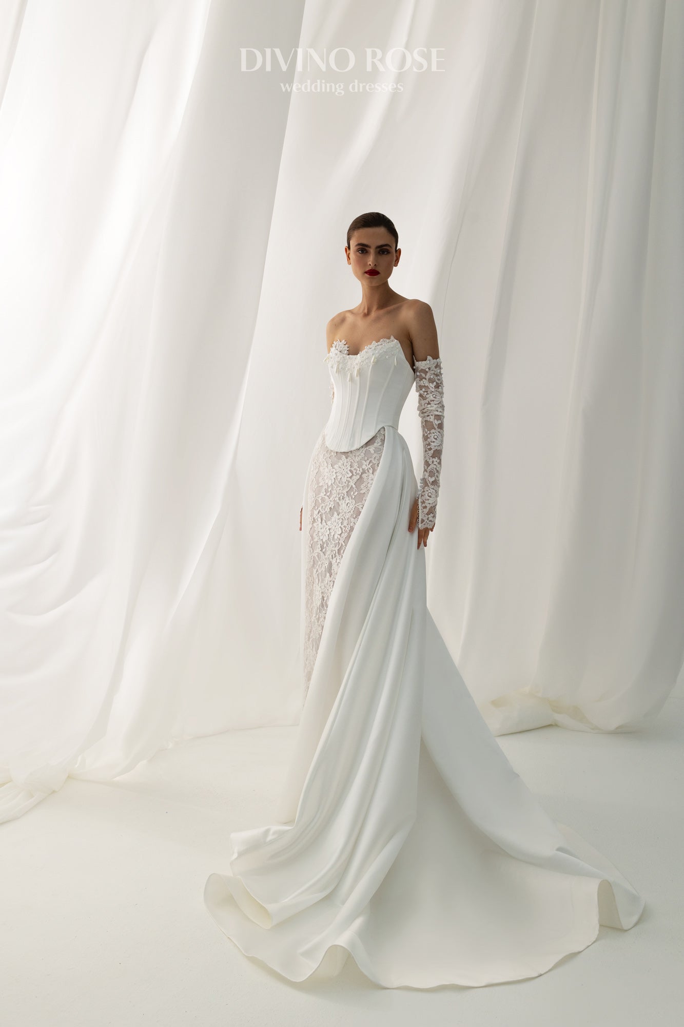 Fitted wedding dress with lace sleeves and corset back.