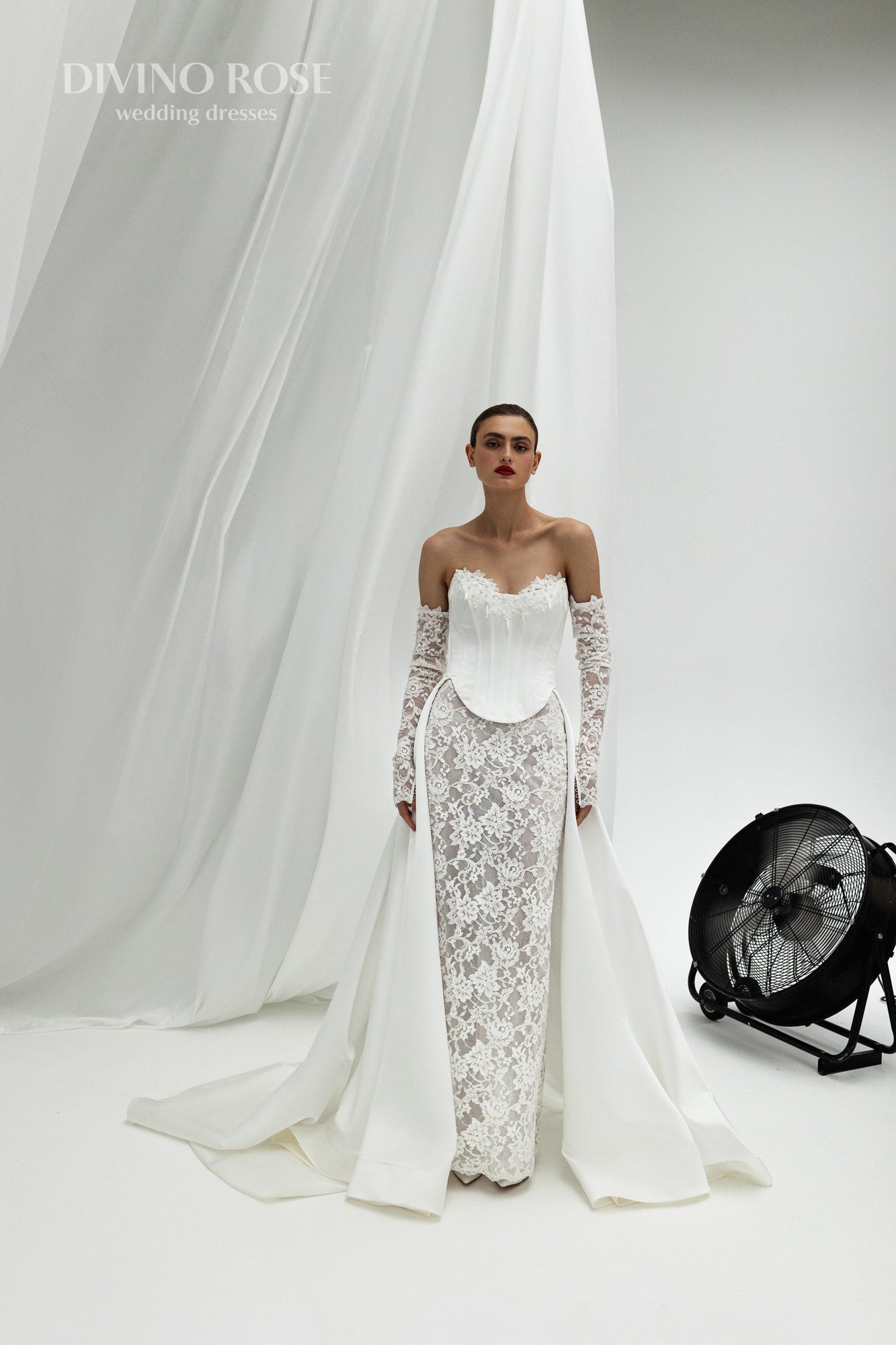Fitted wedding dress with lace sleeves and corset back.
