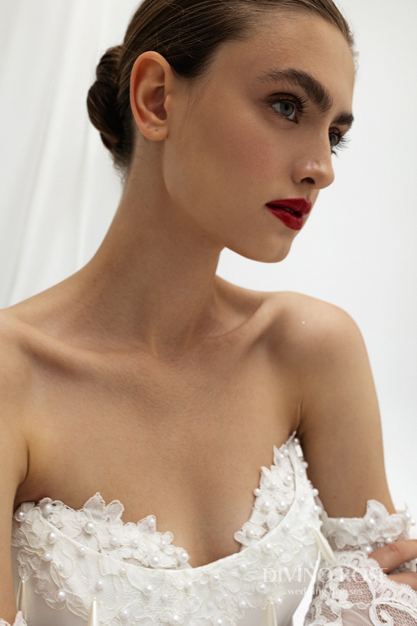 Fitted wedding dress with lace sleeves and corset back.