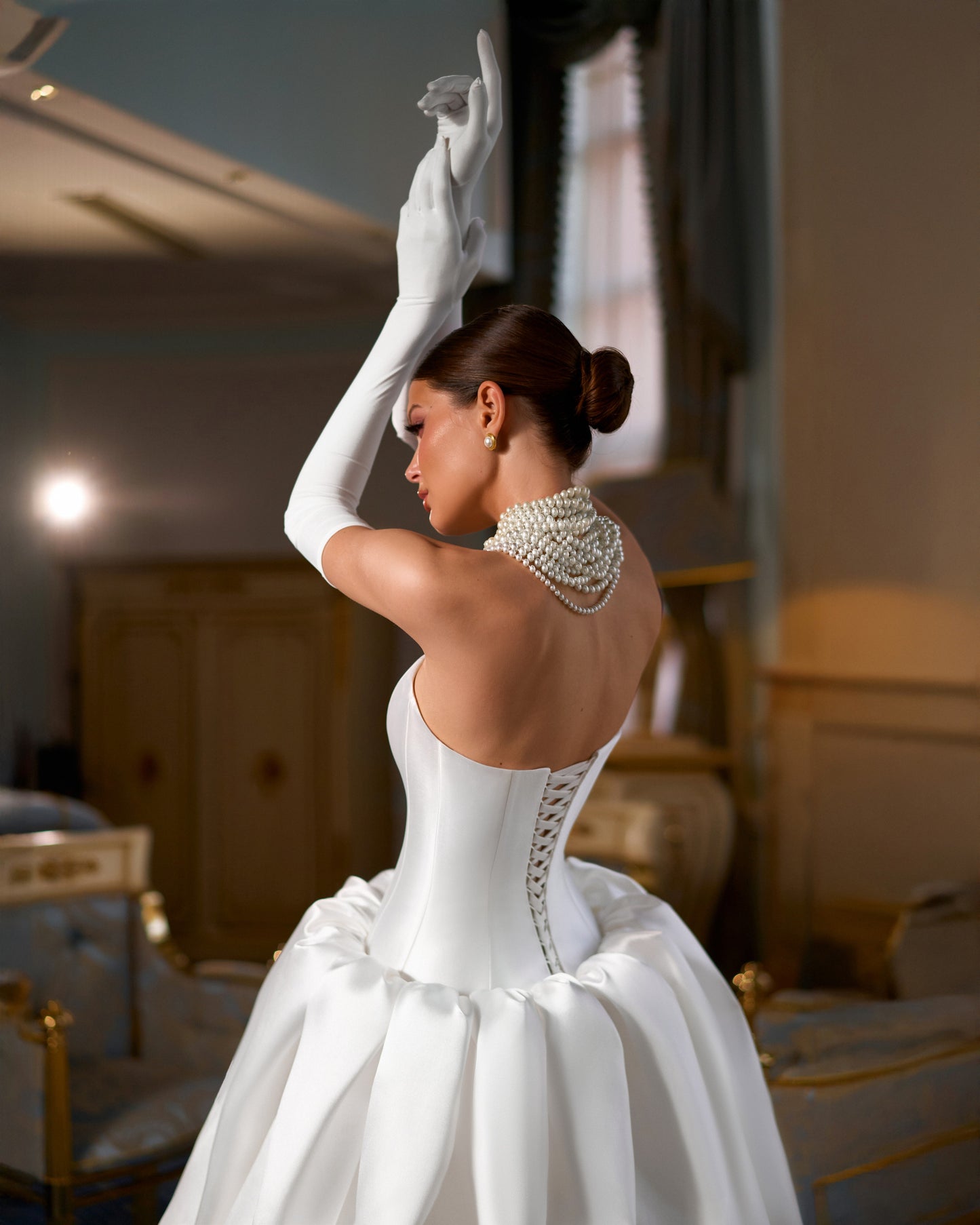 Full-length Mikado A-line wedding dress with straight neckline, prolonged waist, puffy bubble-hem skirt, removable long gloves, open straight-cut back, and lace-up closure for modern bridal style