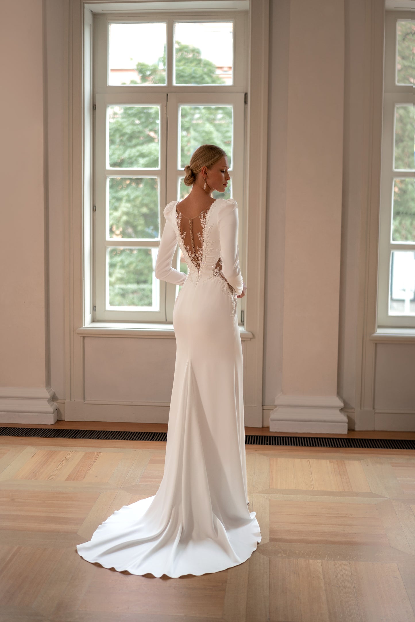 Satin long sleeve sheath wedding dress with deep-V neckline.