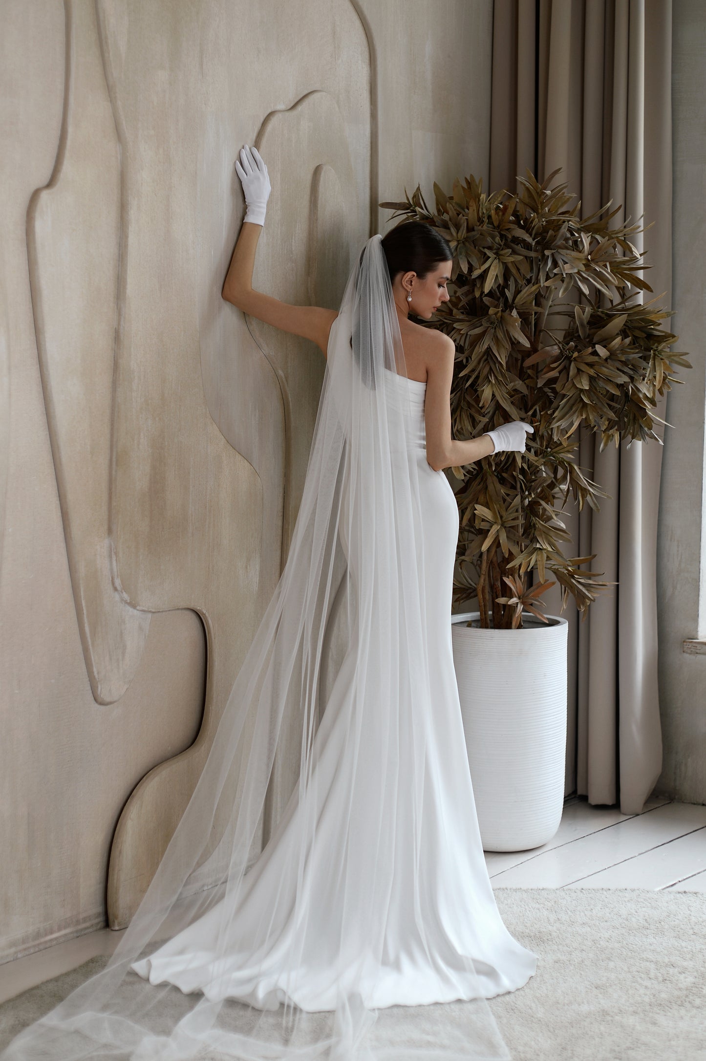 Fitted satin mermaid wedding dress with slit & floral detail.