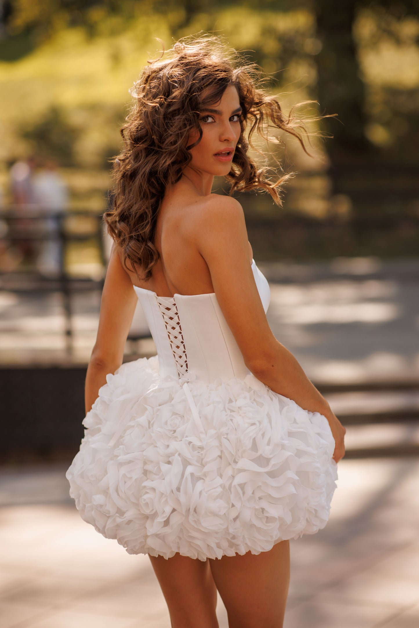 Mini above-knee wedding dress with ruffle skirt and lace-up back