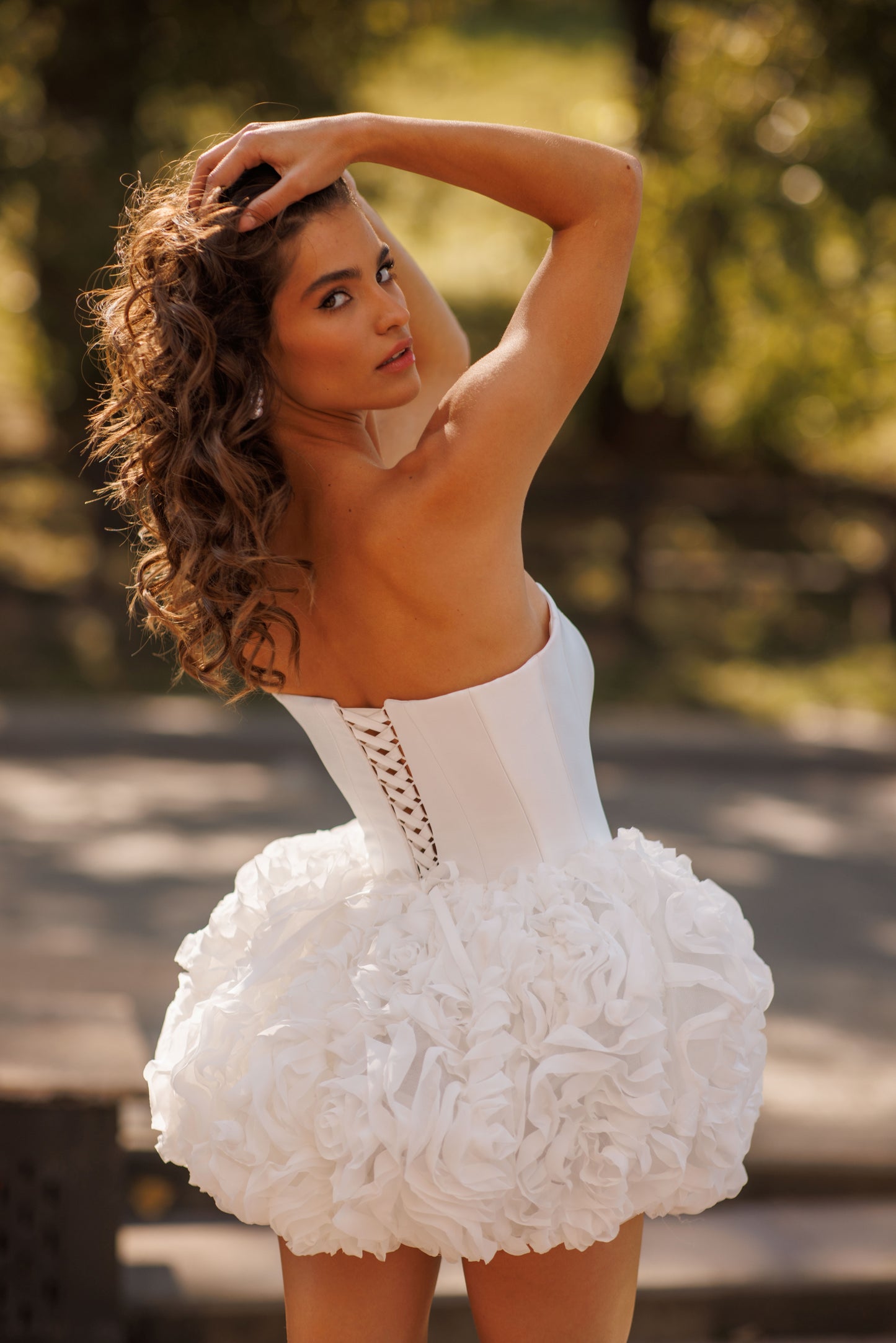 Mini above-knee wedding dress with ruffle skirt and lace-up back