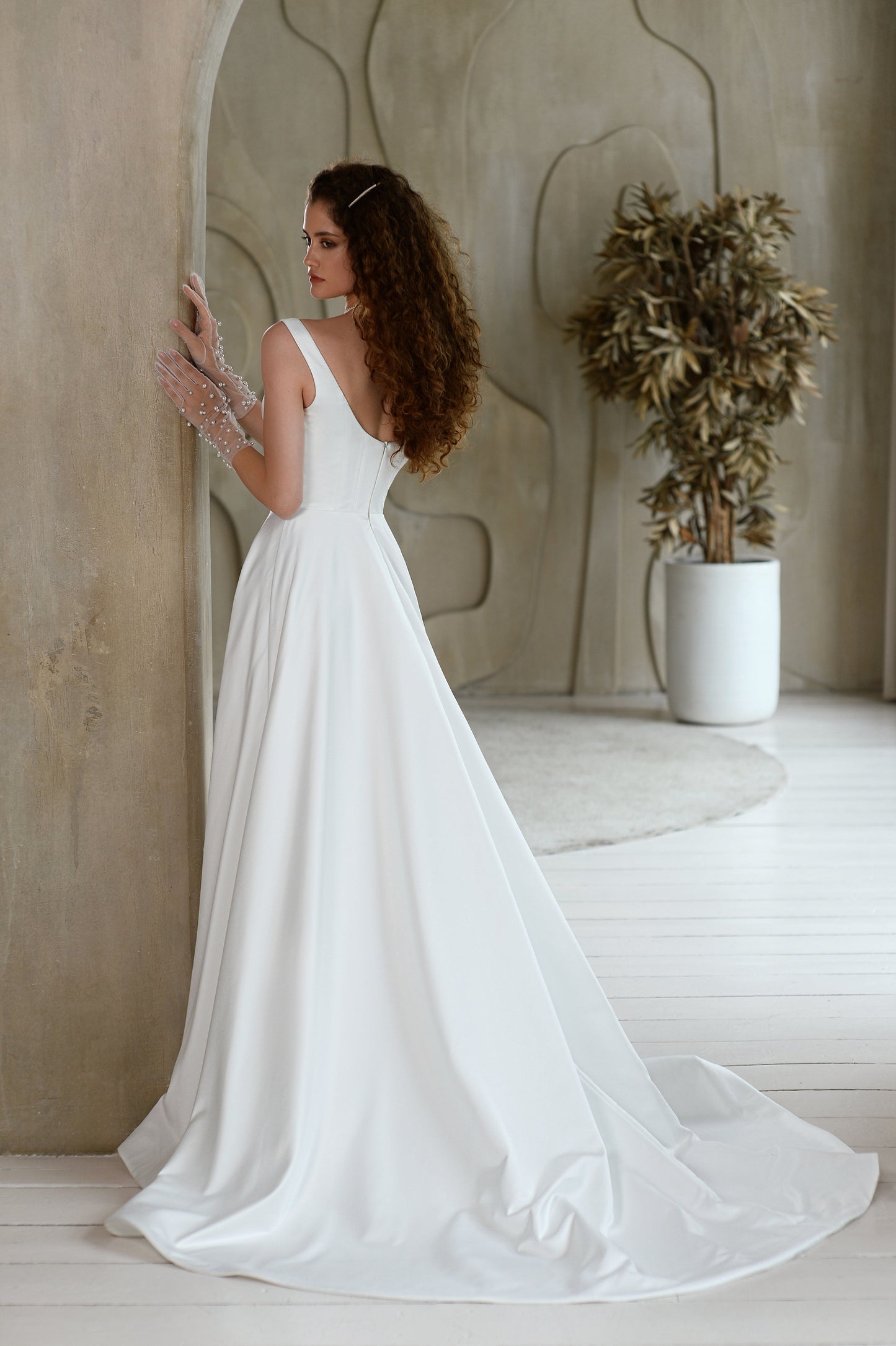 Minimalist A-line sleeveless wedding dress with court train.