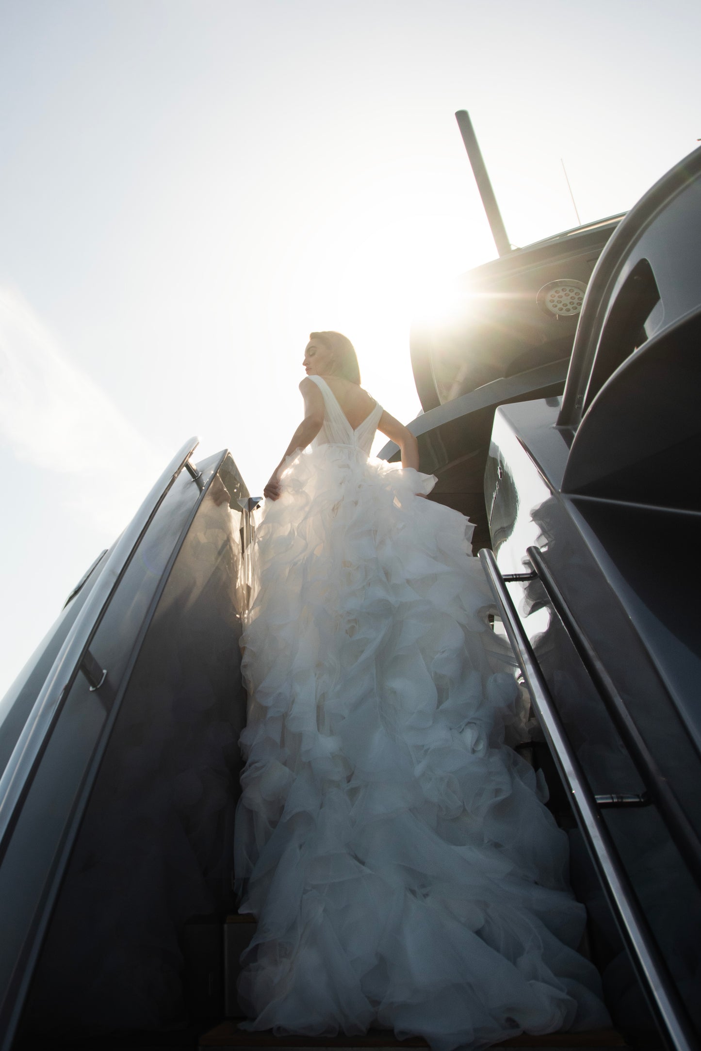 Ethereal tulle ball gown with deep V-neckline and layered airy skirt.