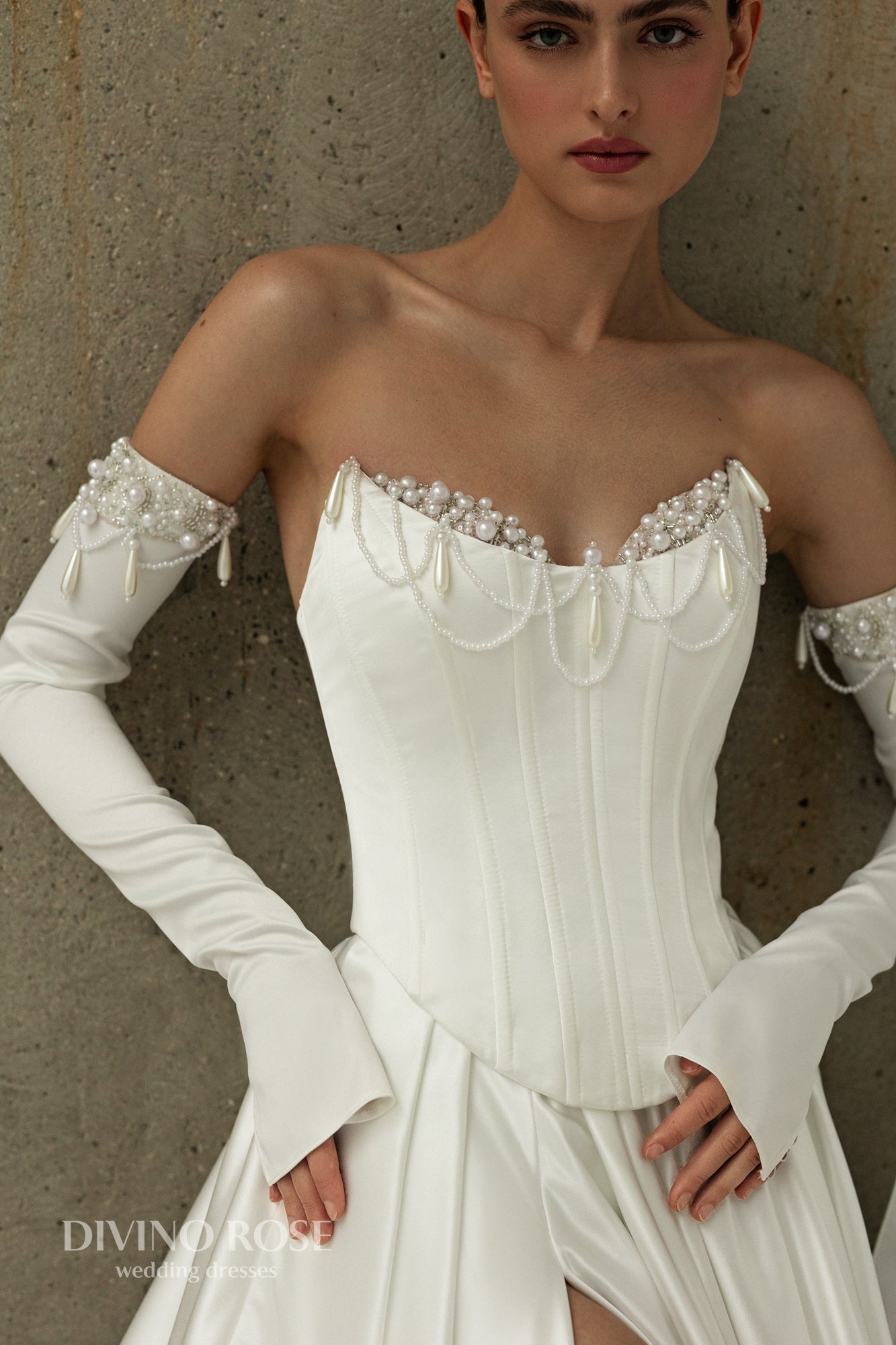 A-line atlas wedding gown with pleated slit skirt and removable sleeves and Pearl details